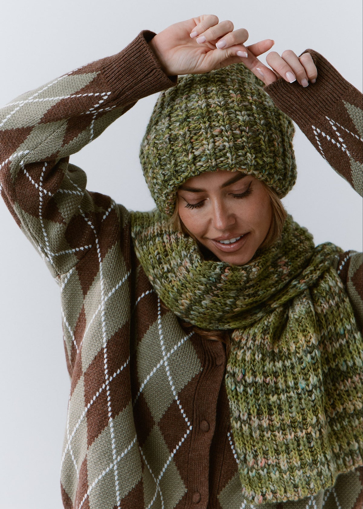 BRIKOLY Apple green multicolor ribbed knit scarf worn by a model with her arms raised, showing the wide ribbed end.