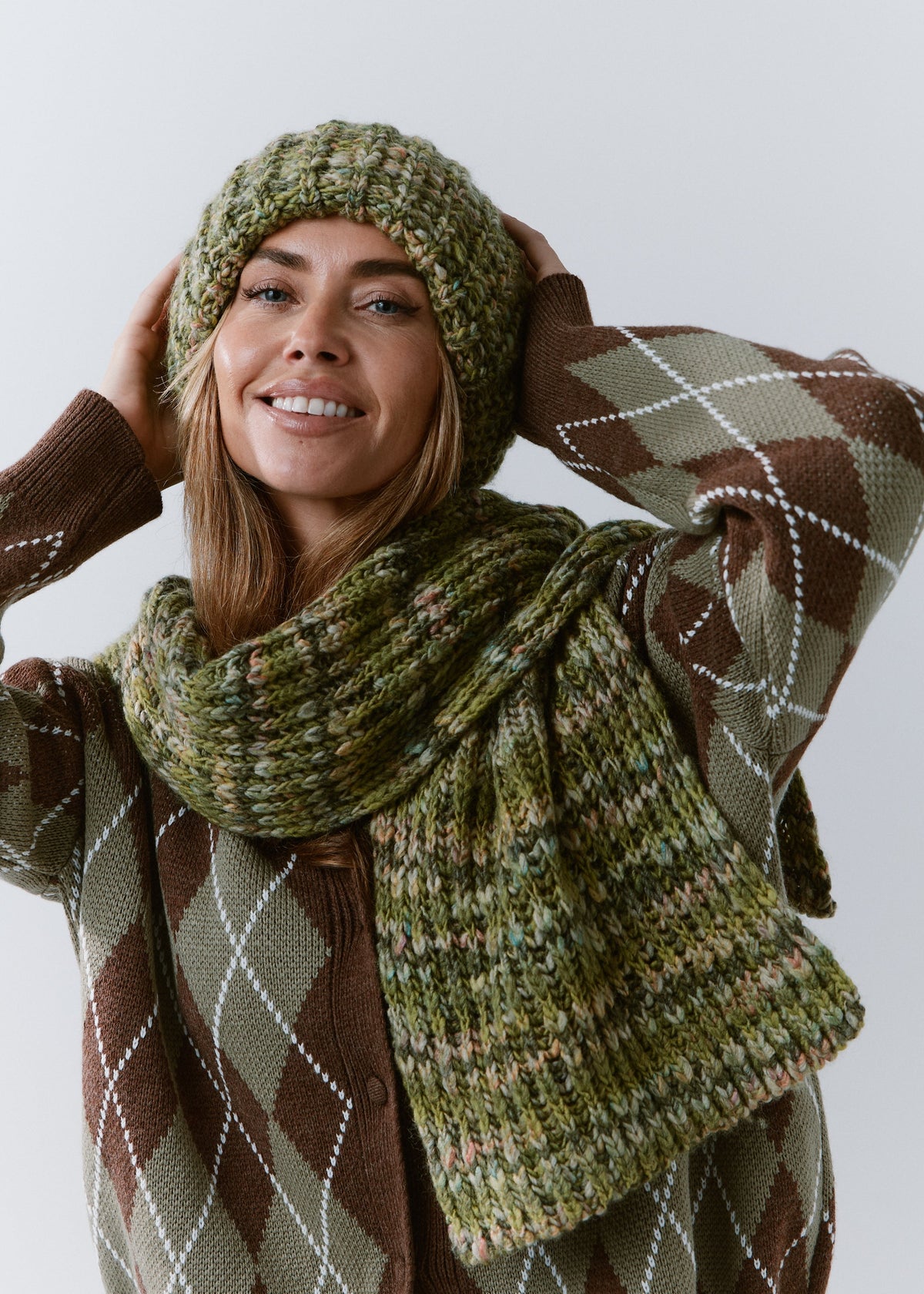 BRIKOLY Apple green multicolor ribbed knit scarf wrapped around a model's neck and styled with a matching green beanie.
