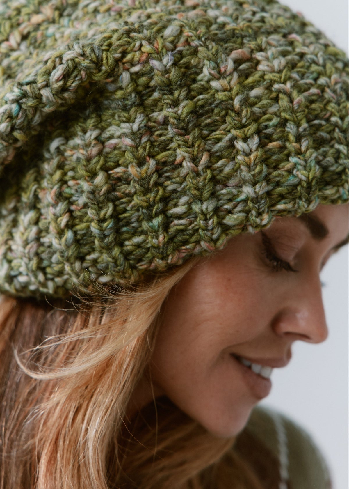 BRIKOLY Apple green oversized knit beanie shown close up to reveal the green multicolor yarn and chunky ribbed knit.