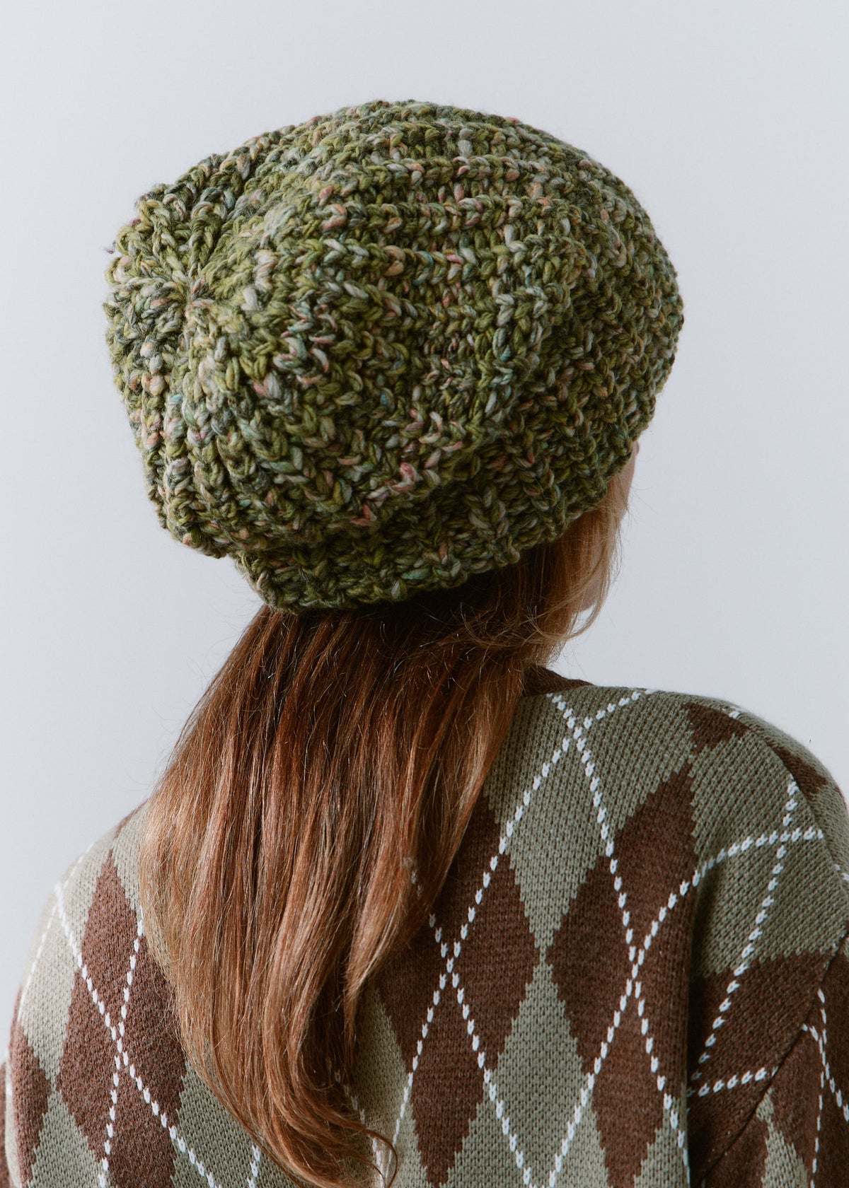 BRIKOLY Apple green oversized knit beanie shown from the back to reveal its knit crown.