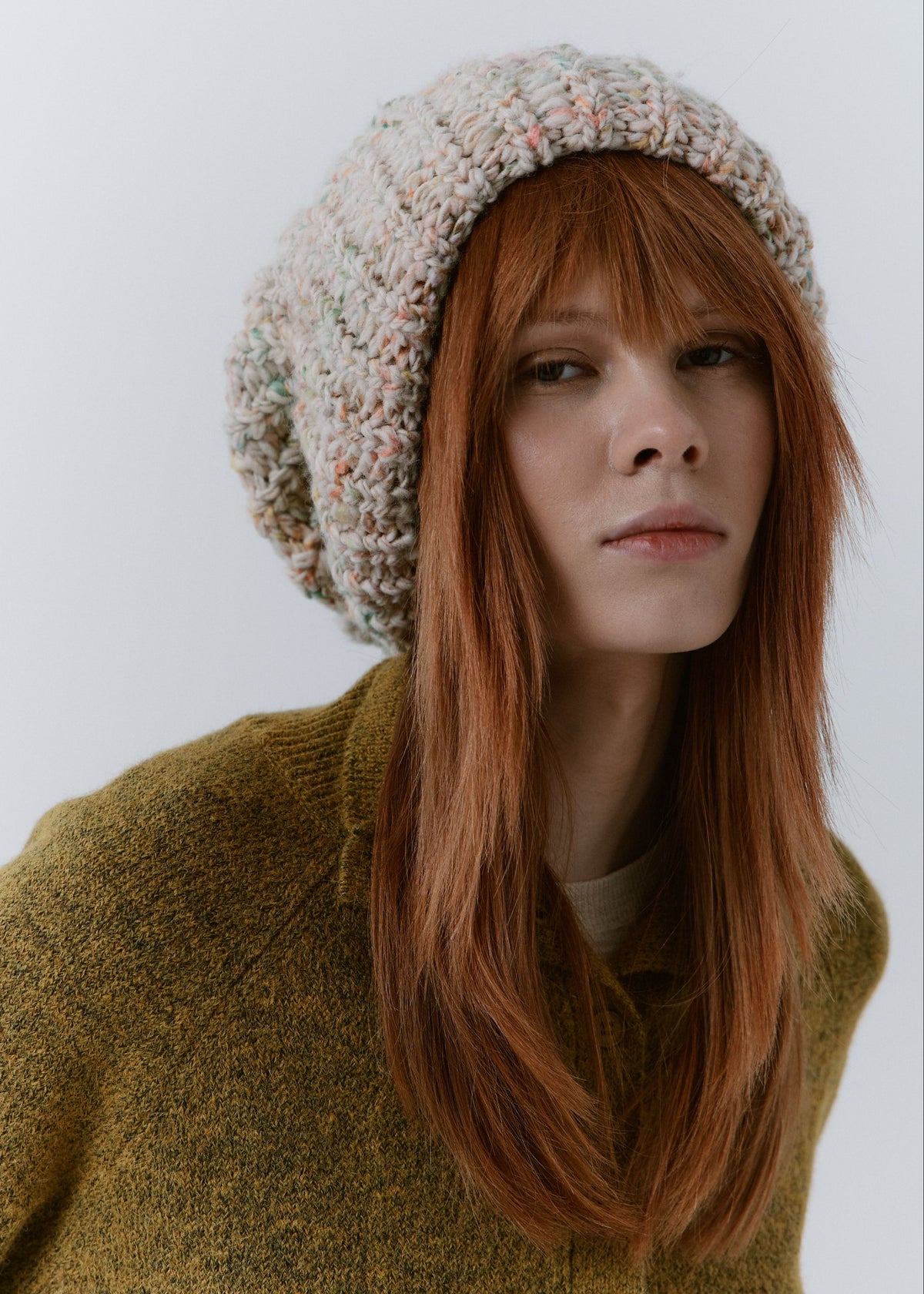 BRIKOLY Snowdrop pale multicolor oversized knit beanie shown in a close front view on a model.