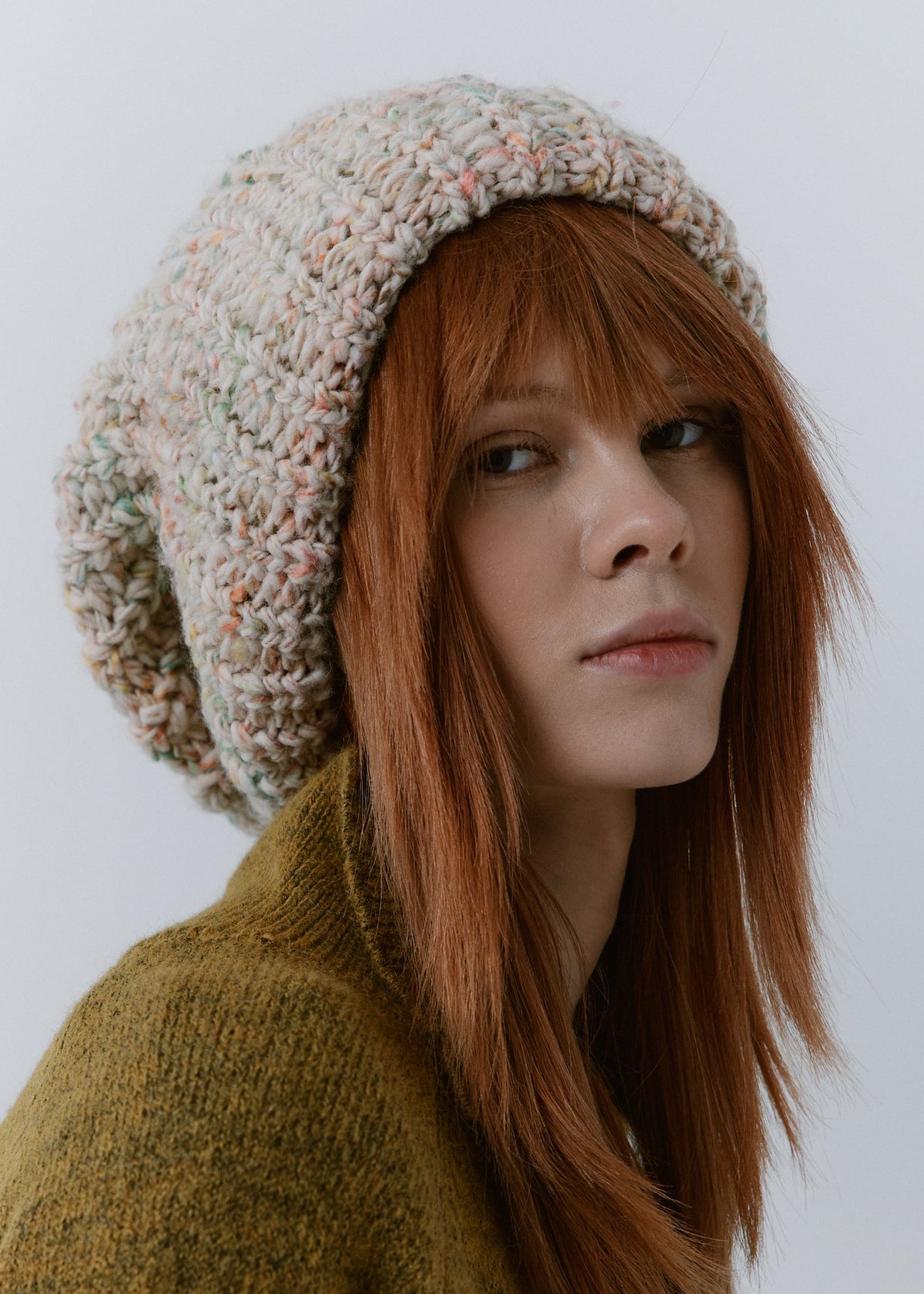 BRIKOLY Snowdrop pale multicolor oversized knit beanie worn by a model in a close three-quarter view.