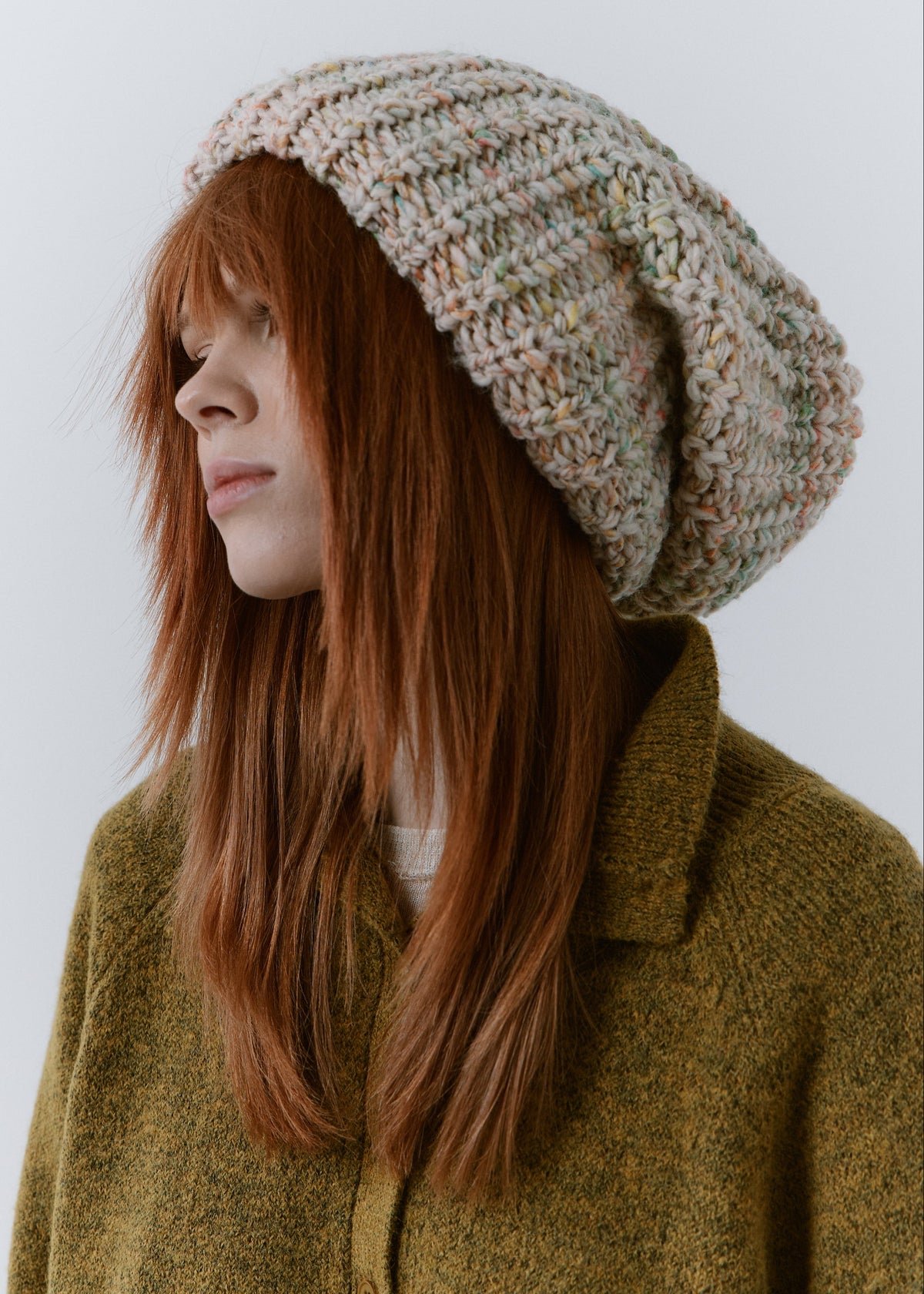 BRIKOLY Snowdrop pale multicolor oversized knit beanie shown in profile with a folded brim and loose crown.