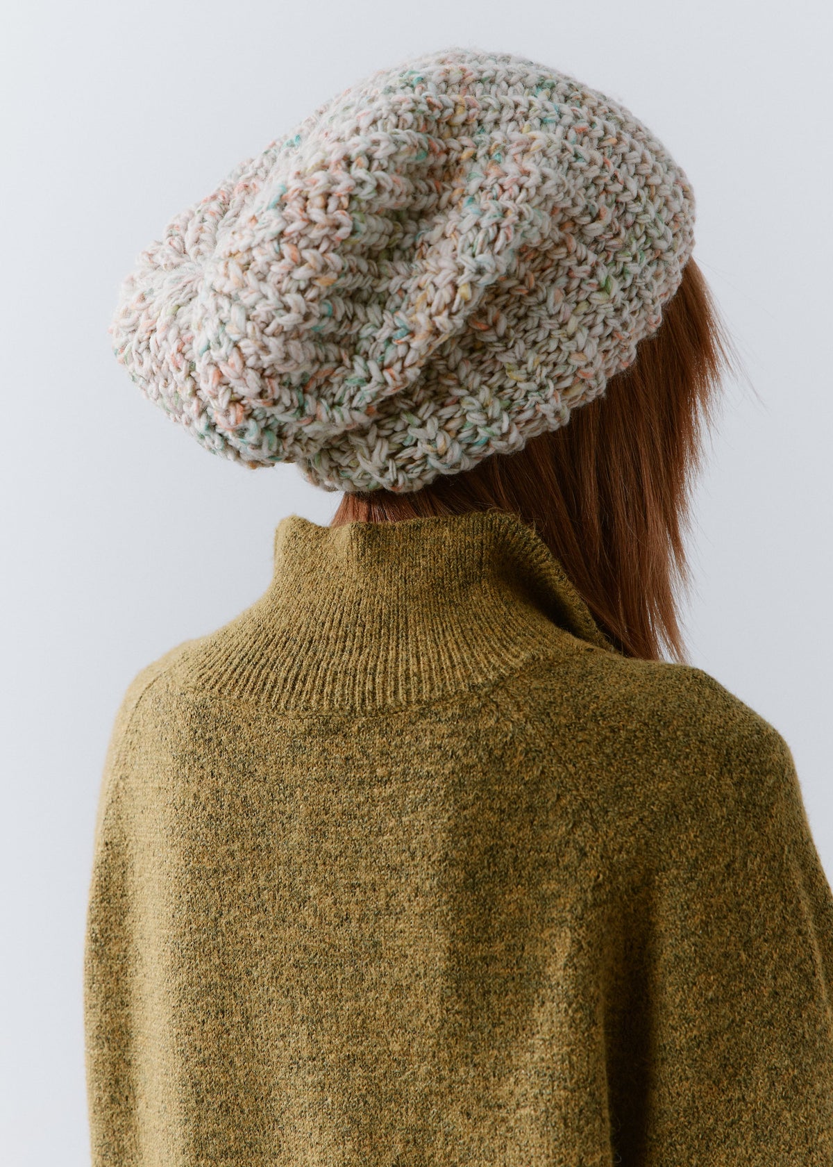 BRIKOLY Snowdrop pale multicolor oversized knit beanie shown from the back to reveal the relaxed crown and knit texture.