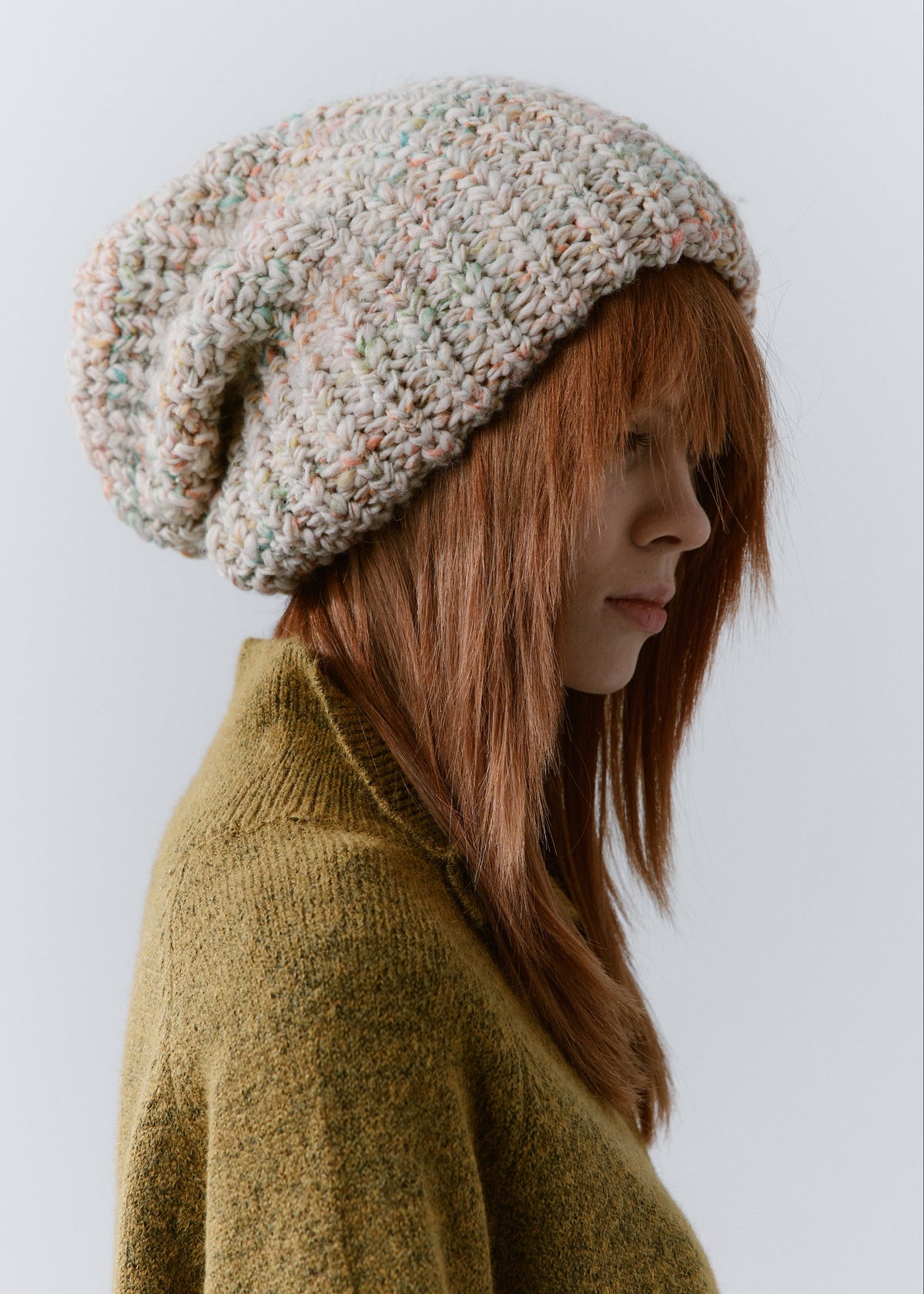 BRIKOLY Snowdrop pale multicolor oversized knit beanie worn by a model in a side view.
