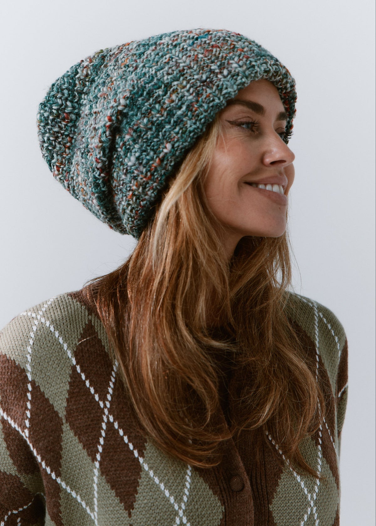London Green and Orange knit beanie: Smiling side portrait