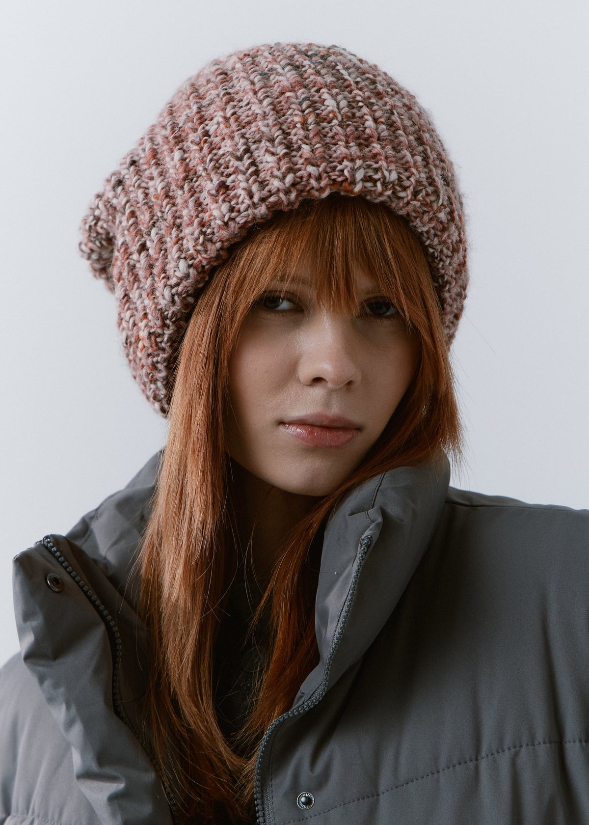 London Rose knit beanie: Front portrait in a gray puffer jacket