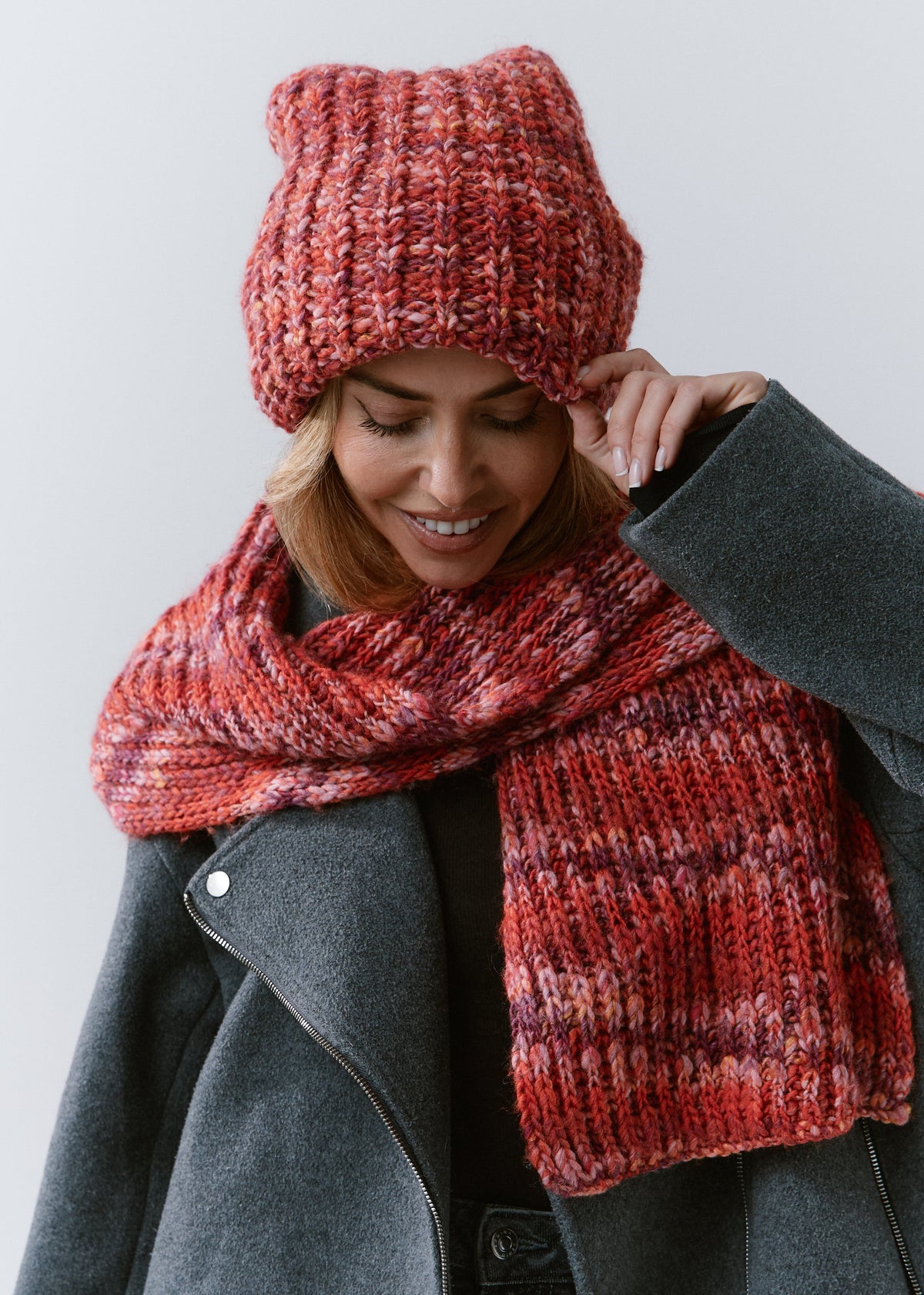 BRIKOLY Red oversized multicolor knit beanie worn by a model looking down with a matching scarf.