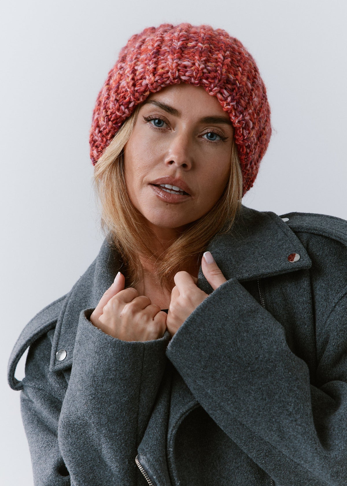 BRIKOLY Red oversized multicolor knit beanie shown in a front view on a model wearing a gray coat.
