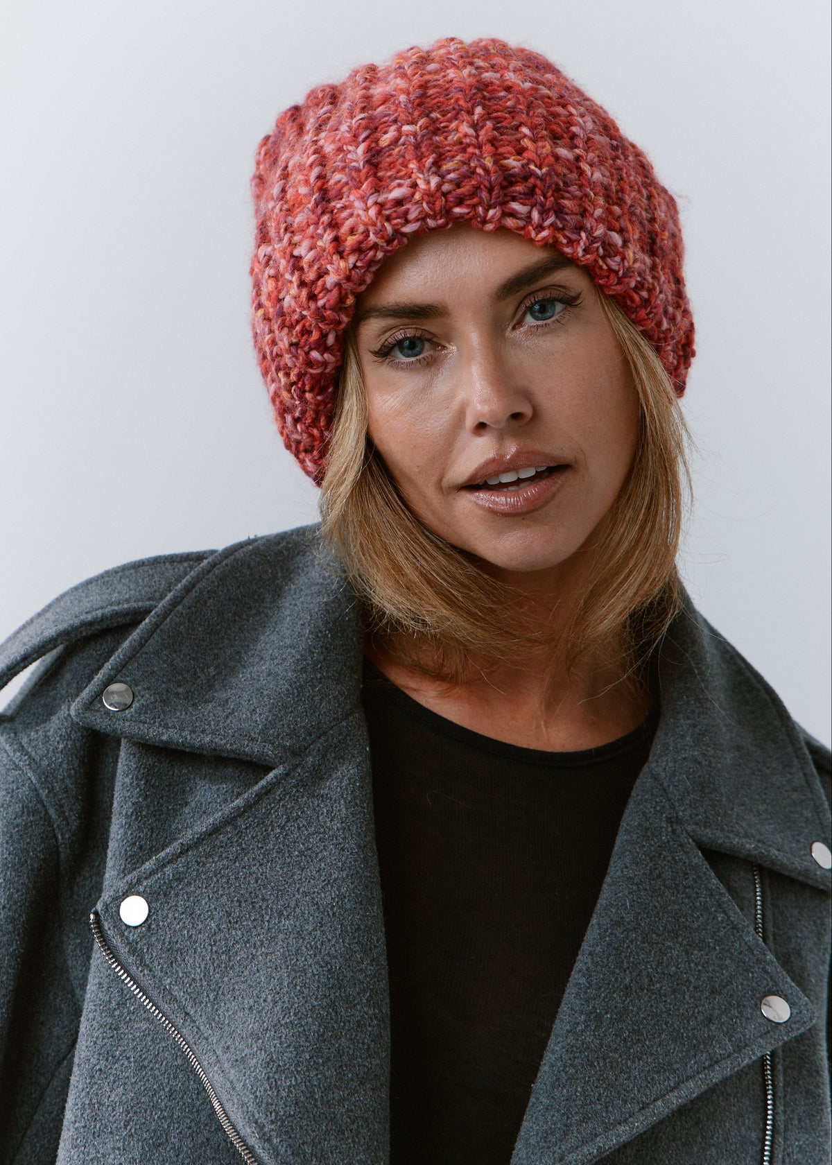 BRIKOLY Red oversized multicolor knit beanie shown in a close front view on a model.