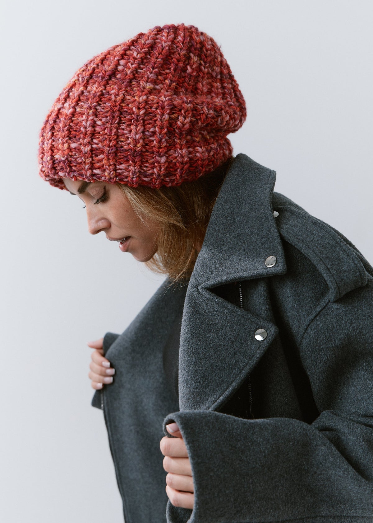 BRIKOLY Red oversized multicolor knit beanie shown in profile on a model looking down.
