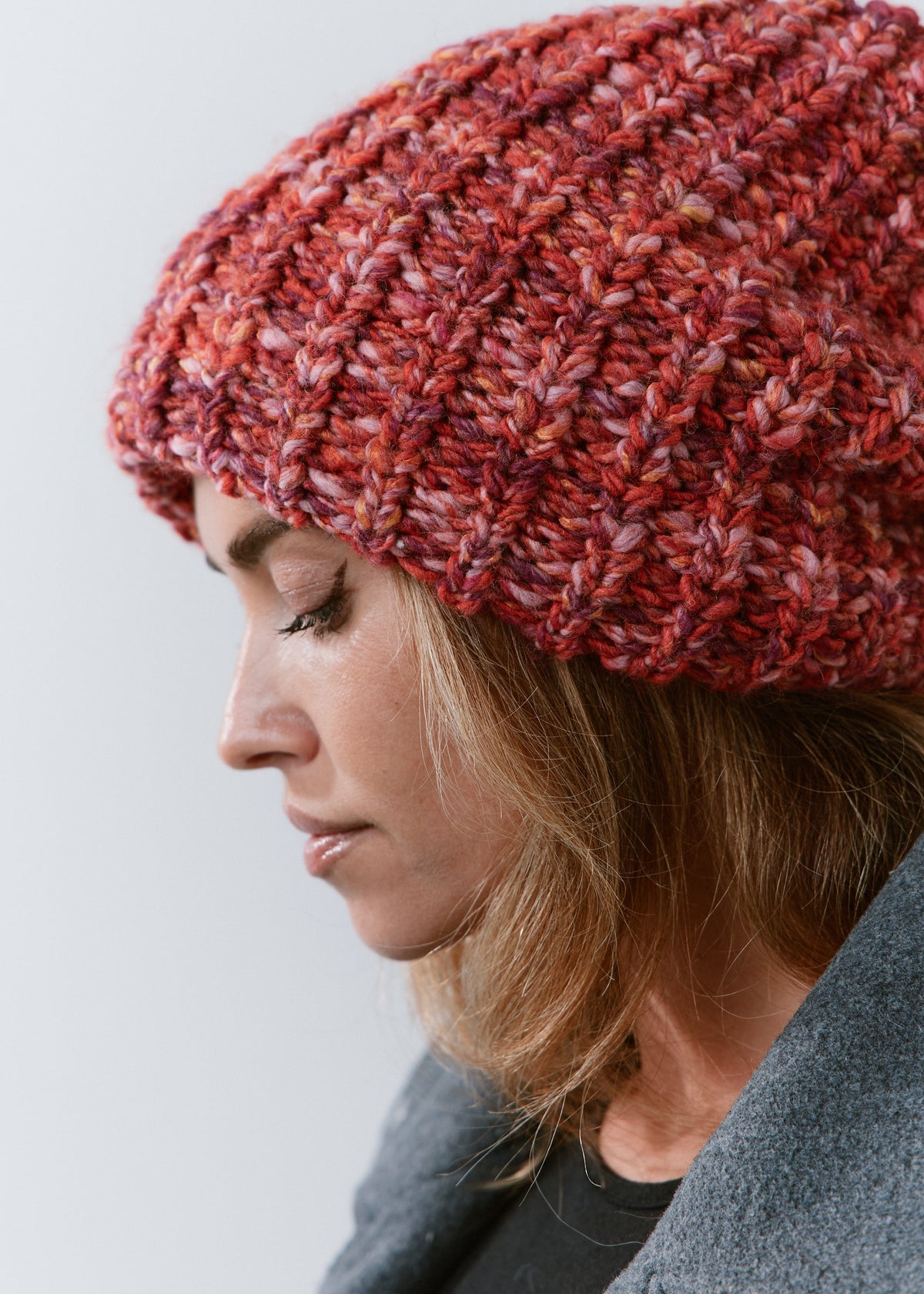 BRIKOLY Red oversized multicolor knit beanie shown close up to reveal the red multicolor yarn and ribbed brim.