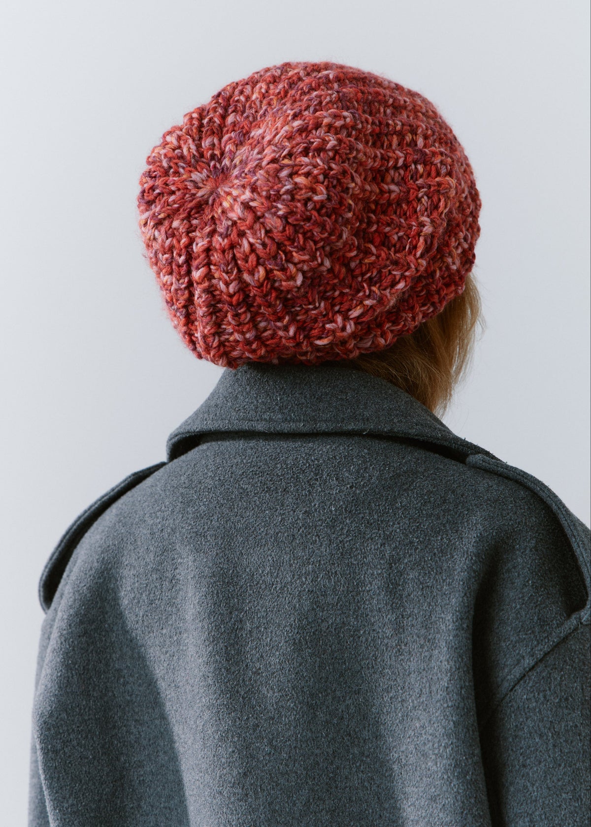 BRIKOLY Red oversized multicolor knit beanie shown from the back to reveal the chunky knit crown.