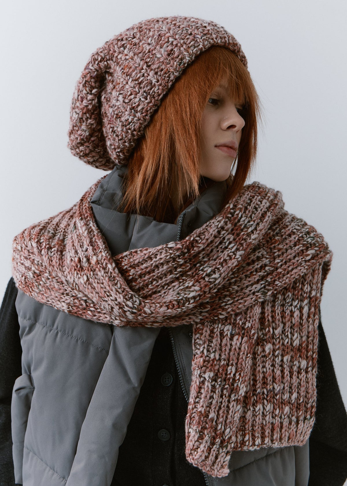 BRIKOLY Rose oversized multicolor knit beanie worn by a model with a matching scarf wrapped around her shoulders.