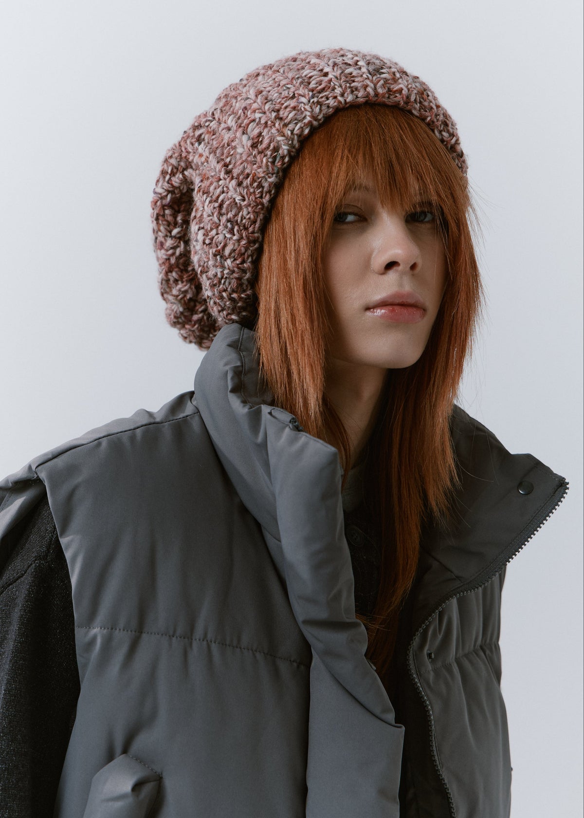 BRIKOLY Rose oversized multicolor knit beanie worn by a model with a gray padded vest.