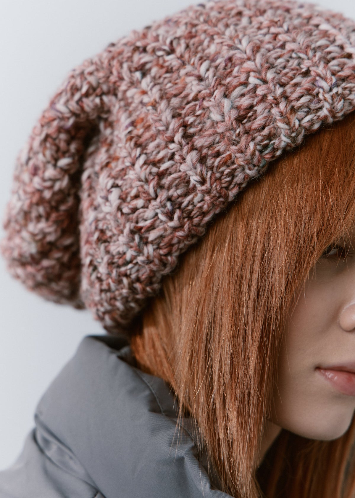 BRIKOLY Rose oversized multicolor knit beanie shown close up to reveal the pink and brown multicolor yarn and folded brim.