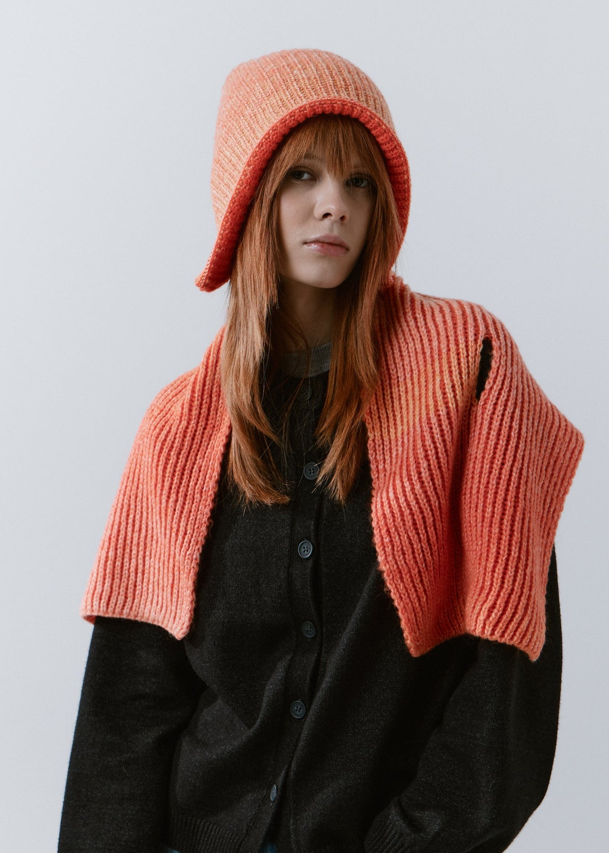Lisse Orange & Red reversible wool beanie: Outfit view with matching scarf draped over shoulders, sold separately