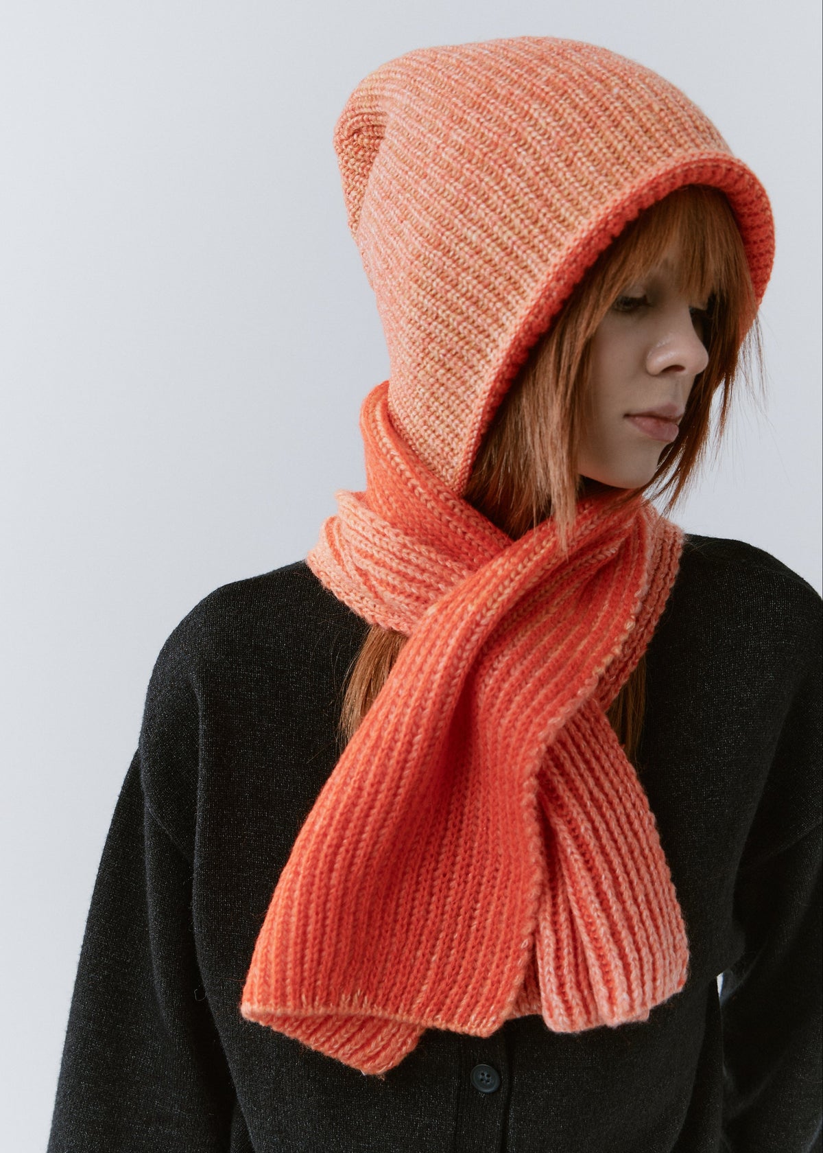 Lisse Orange & Red reversible wool beanie: Three-quarter portrait with matching scarf, sold separately