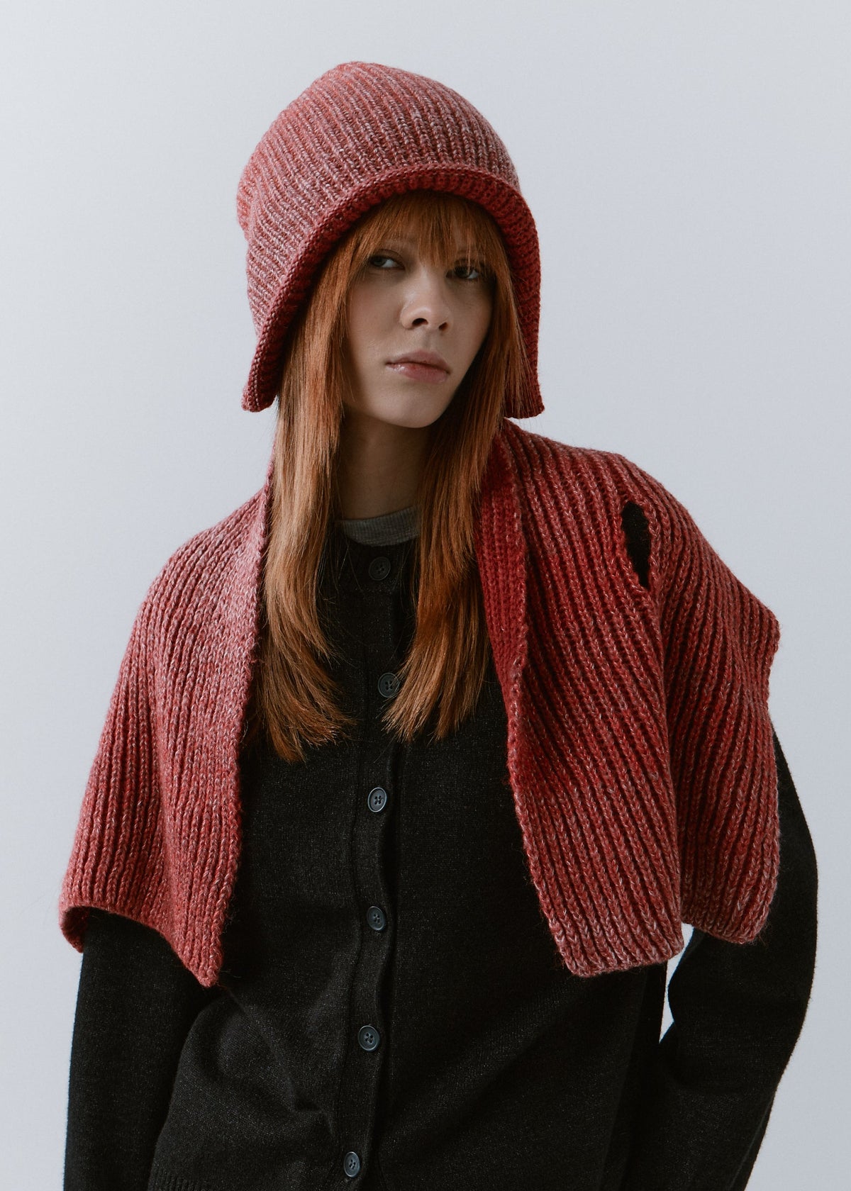 BRIKOLY Lisse Cherry reversible ribbed knit beanie worn by a model with a matching scarf draped over the shoulders.