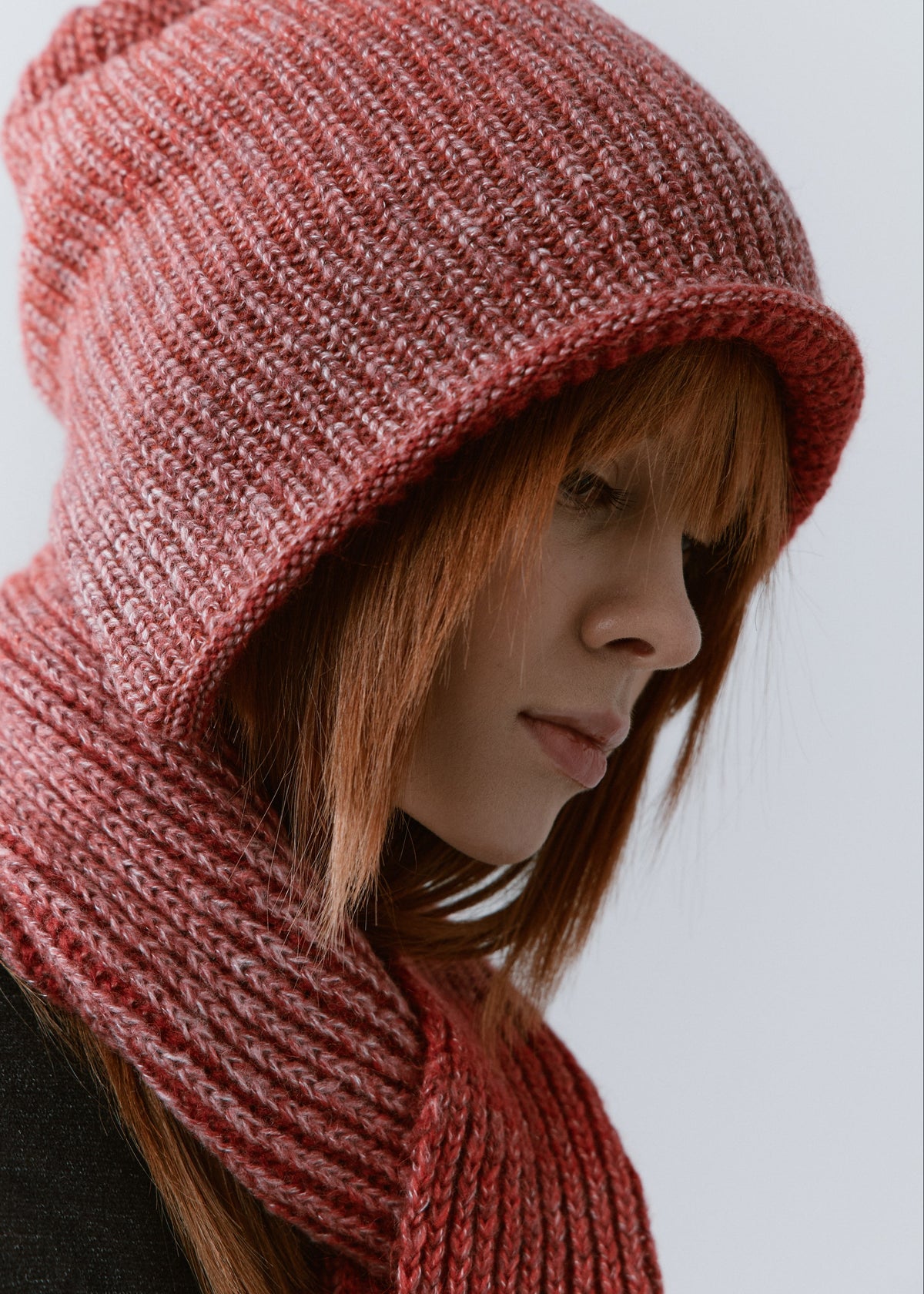 BRIKOLY Lisse Cherry reversible ribbed knit beanie shown close up to reveal its rose-red ribbed knit and red inner edge.