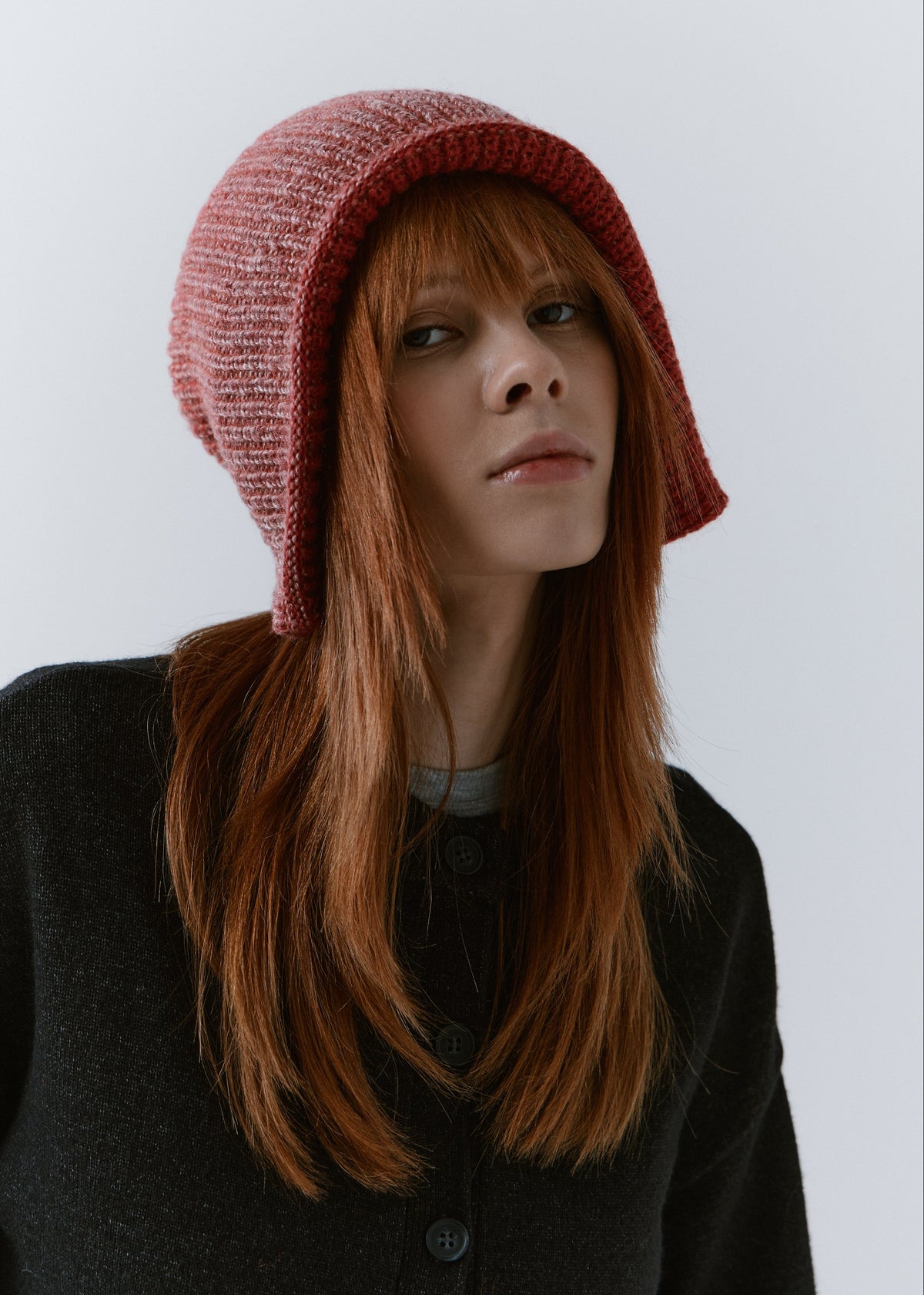 BRIKOLY Lisse Cherry reversible ribbed knit beanie worn by a model with the brim turned outward.