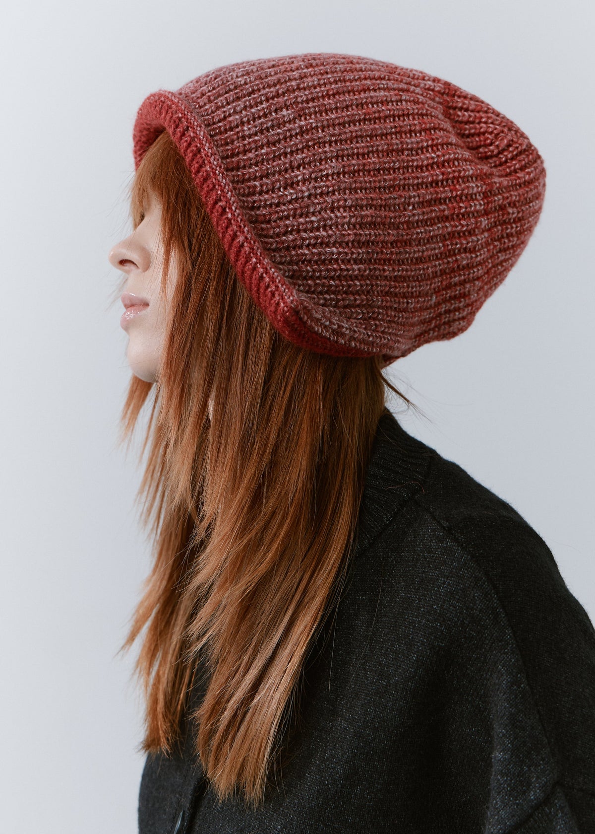BRIKOLY Lisse Cherry reversible ribbed knit beanie shown in a side view to reveal the slouchy shape.