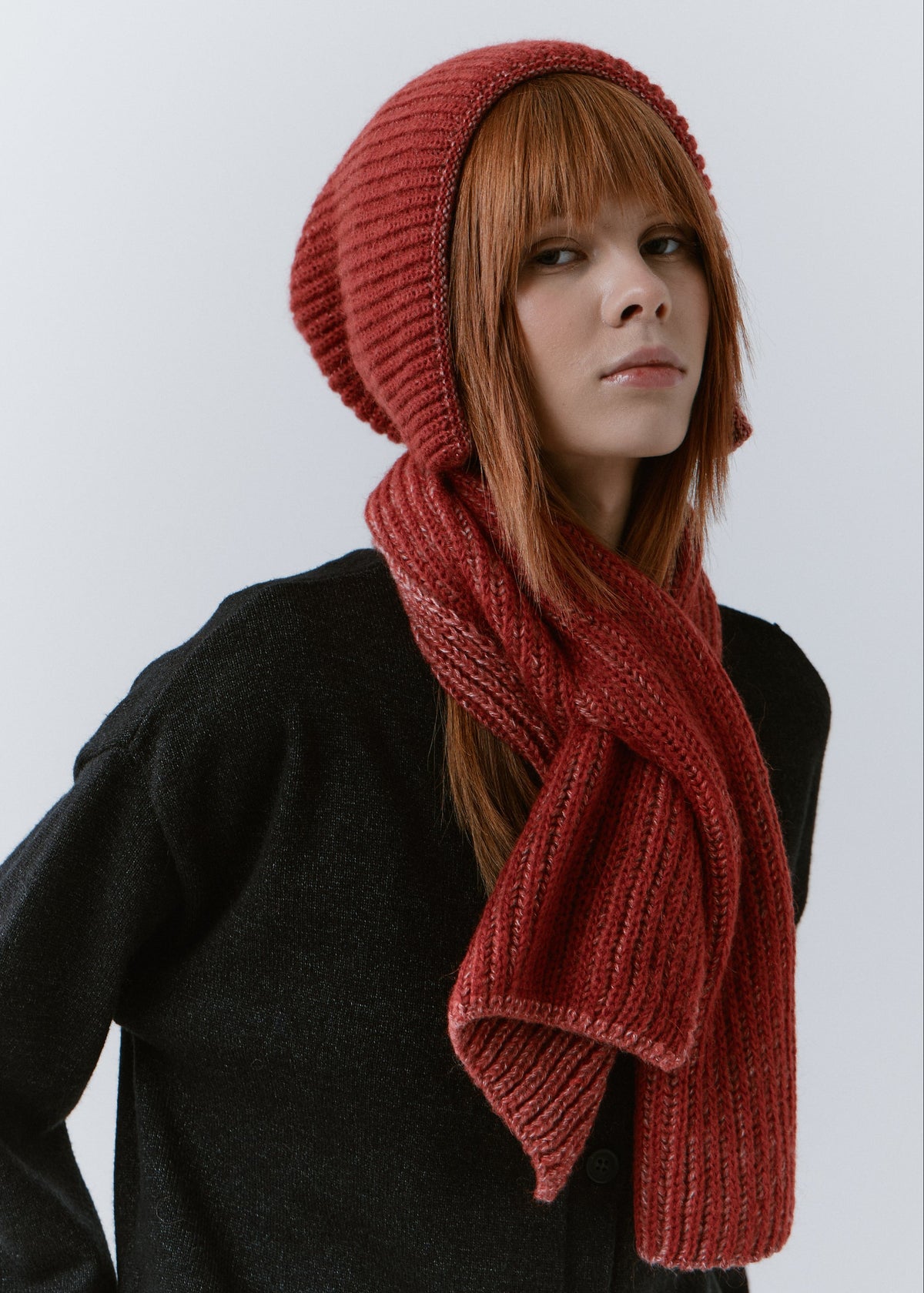 BRIKOLY Lisse Cherry ribbed knit scarf secured around a model's neck with the ribbed ends in front.