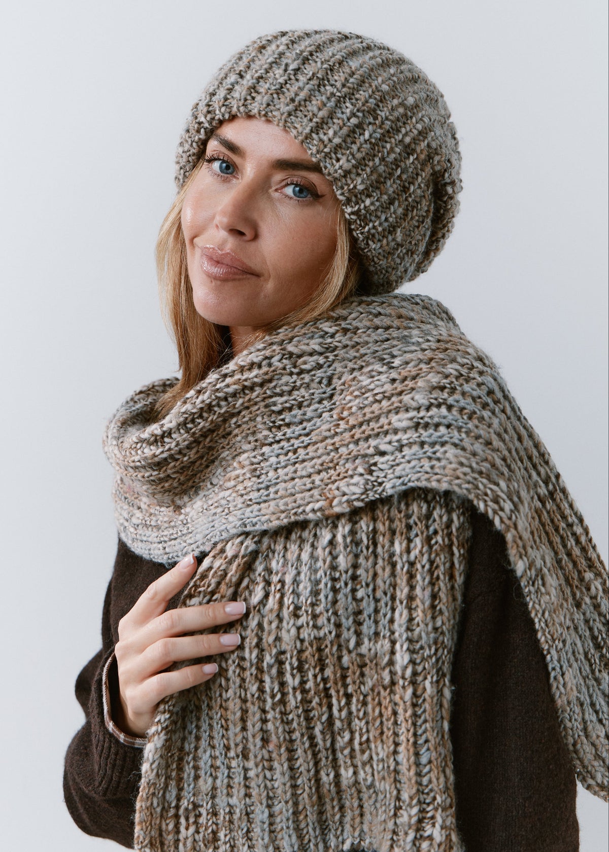 London Gray knit beanie: Three-quarter portrait holding matching scarf, sold separately