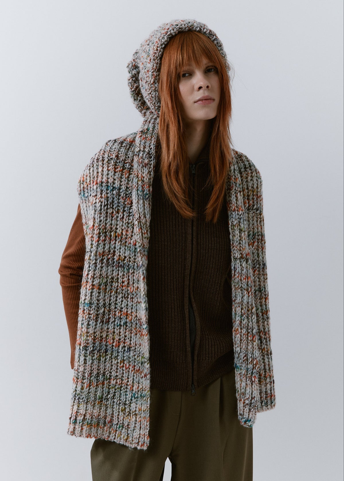 BRIKOLY FAN oversized multicolor knit beanie worn by a model with a matching scarf hanging down the front.