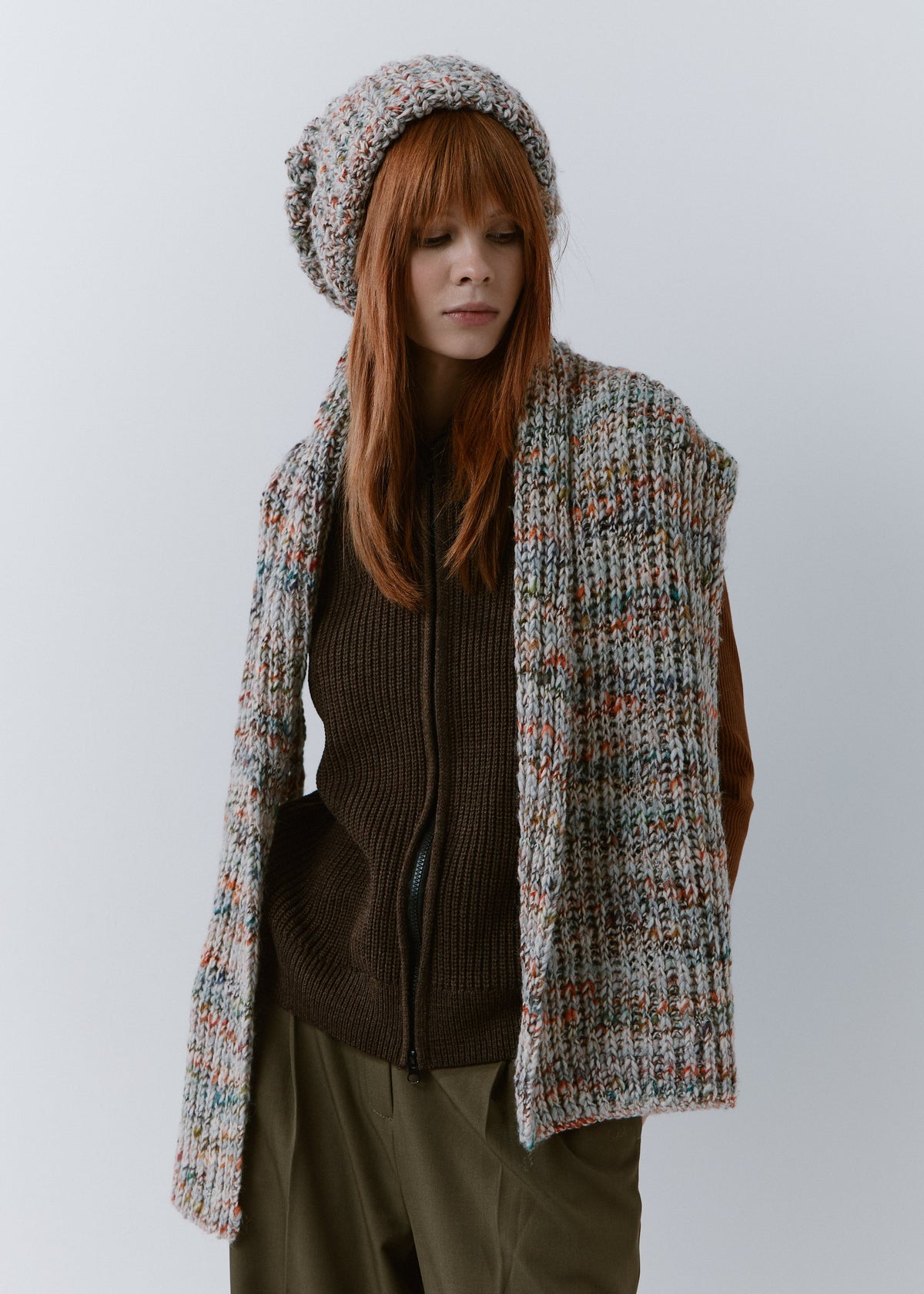BRIKOLY FAN multicolor ribbed knit scarf draped over the shoulders with both ends hanging in front on a model.