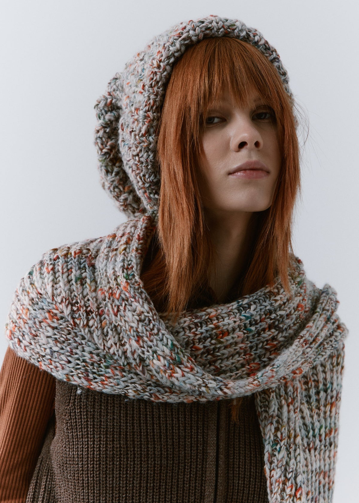 BRIKOLY FAN multicolor ribbed knit scarf wrapped around the shoulders, with one end hanging in front on a model.