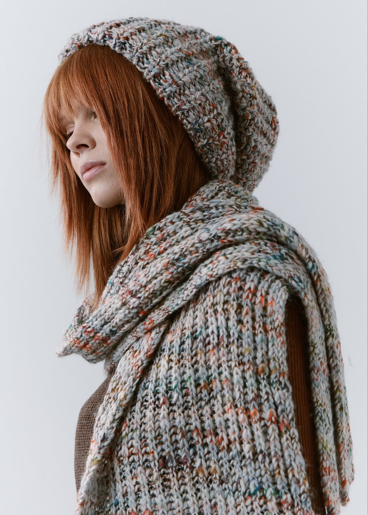 BRIKOLY FAN multicolor ribbed knit scarf draped over one shoulder in a close side view on a model.