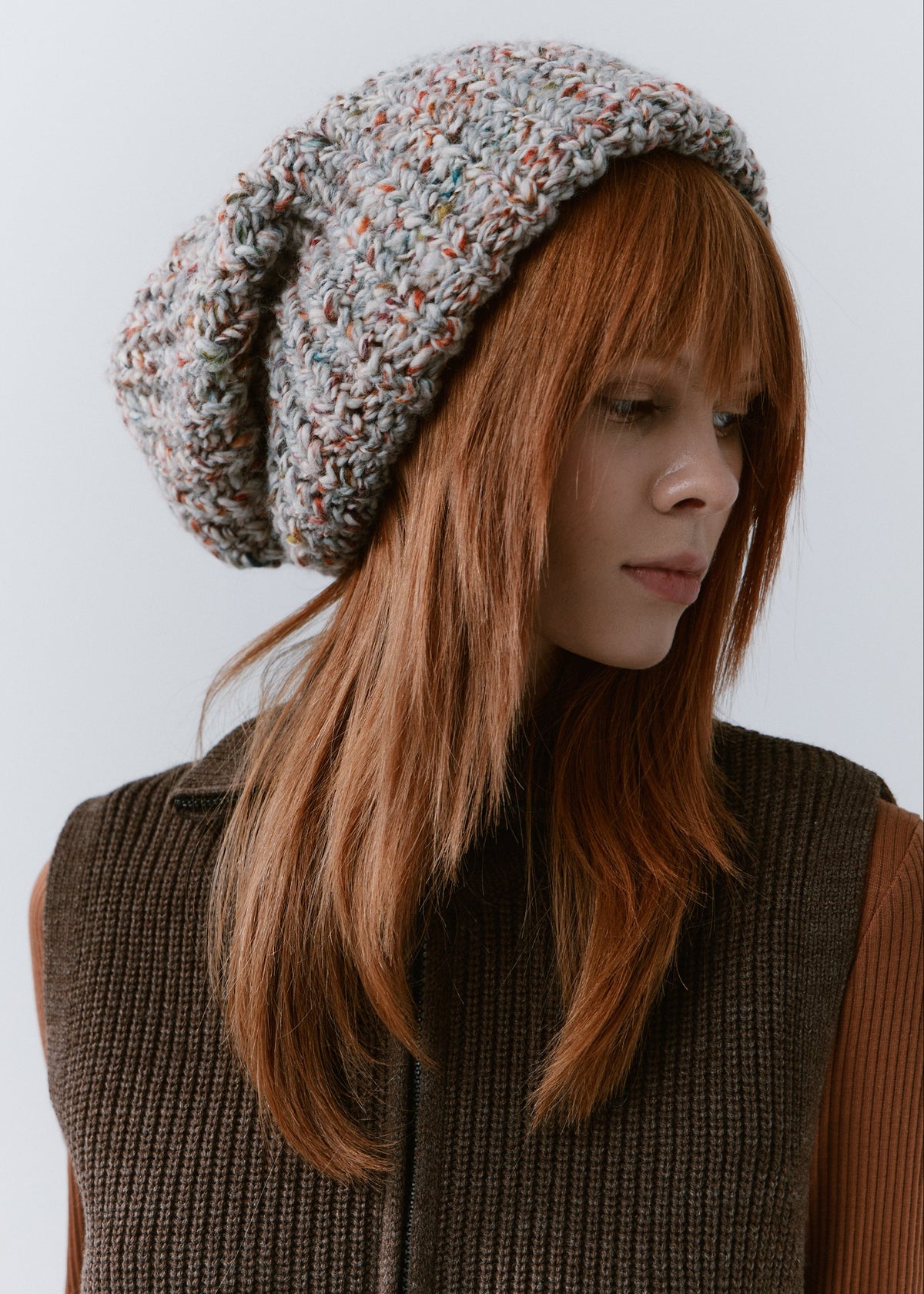 BRIKOLY FAN oversized multicolor knit beanie worn by a model looking to the side.