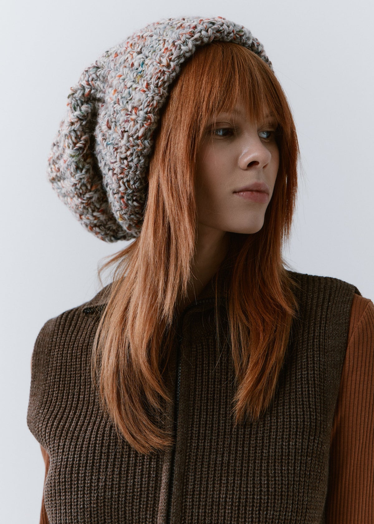 BRIKOLY FAN oversized multicolor knit beanie worn by a model in a three-quarter view.