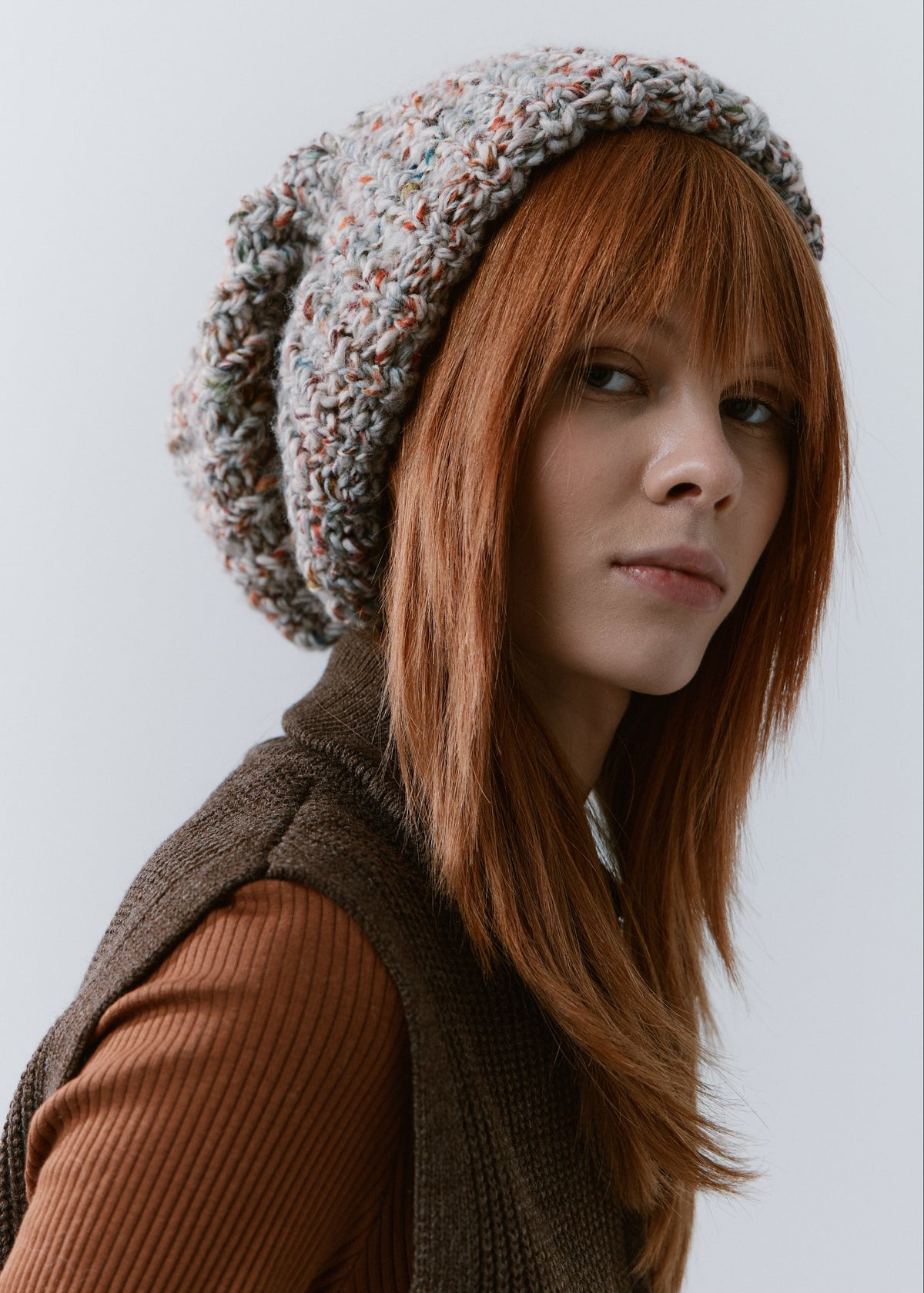 BRIKOLY FAN oversized multicolor knit beanie worn by a model looking toward the camera.