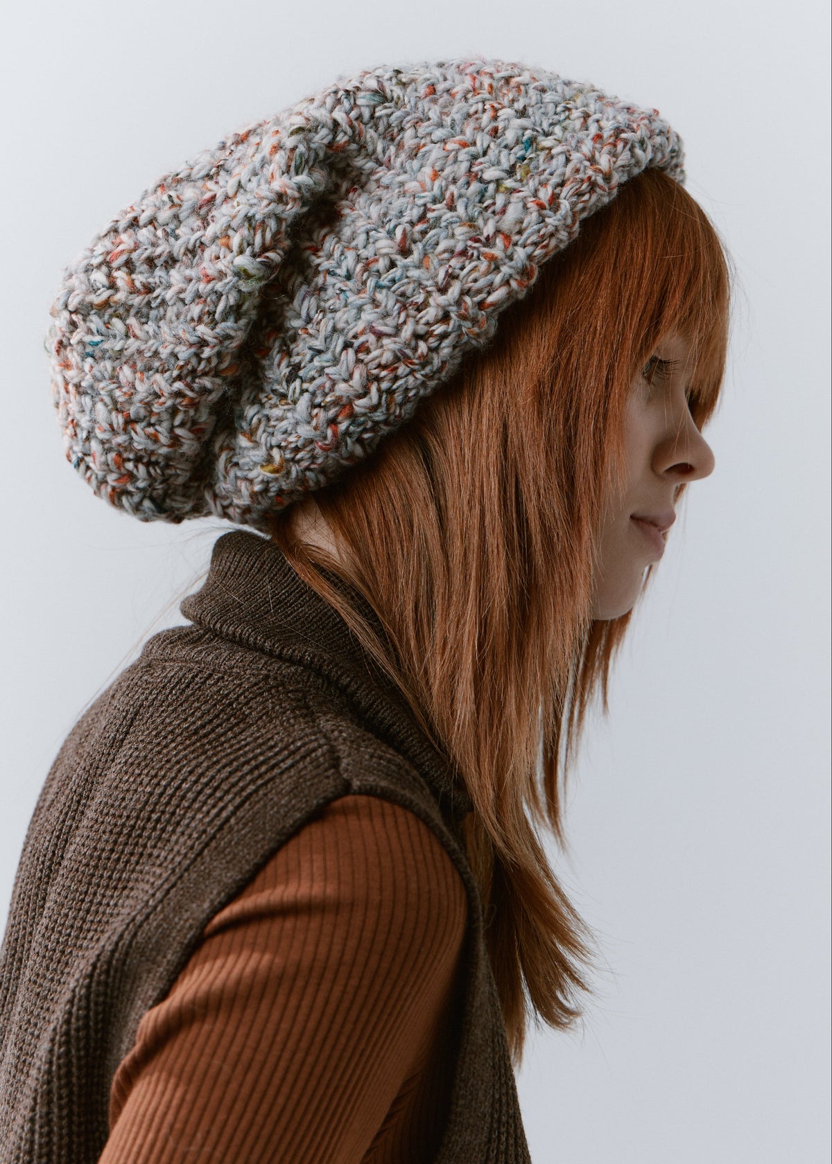 BRIKOLY FAN oversized multicolor knit beanie shown in profile to reveal its folded brim and loose crown.