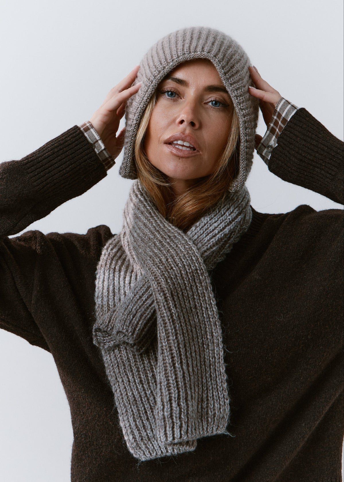 BRIKOLY Lisse Gray ribbed knit scarf wrapped around a model's neck over a dark sweater.