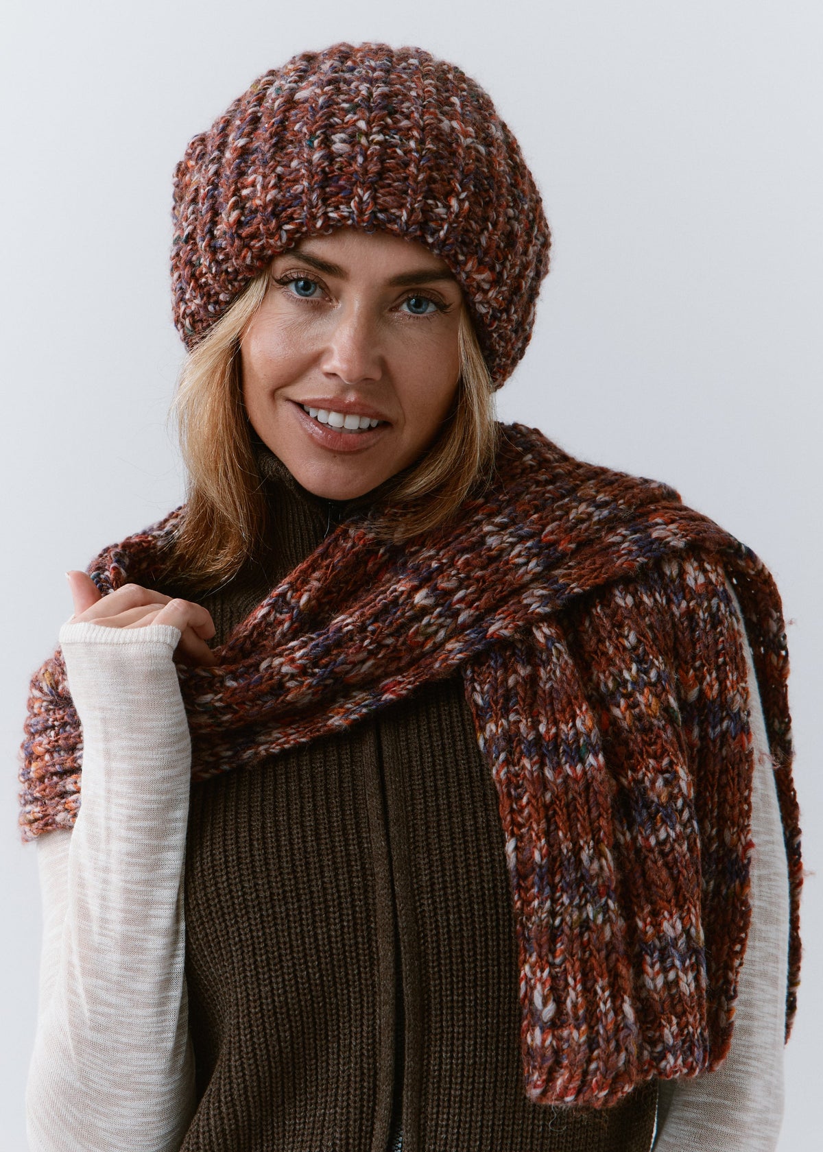 BRIKOLY Eggplant multicolor ribbed knit scarf wrapped around a model's neck with one ribbed end hanging in front.