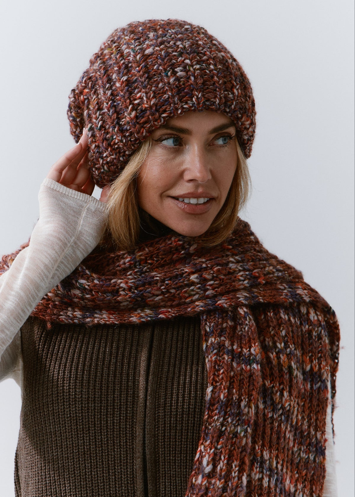 BRIKOLY Eggplant multicolor ribbed knit scarf worn by a model looking to the side, styled with a matching beanie.