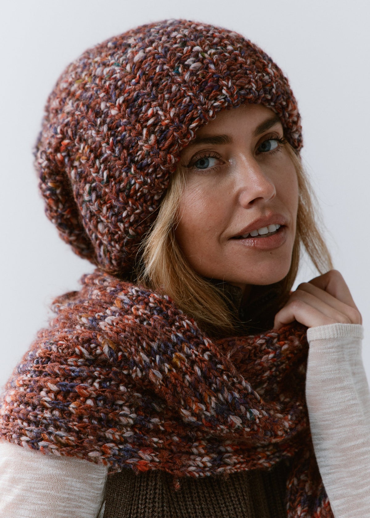 BRIKOLY Eggplant oversized multicolor knit beanie shown close up on a model wearing a matching scarf.