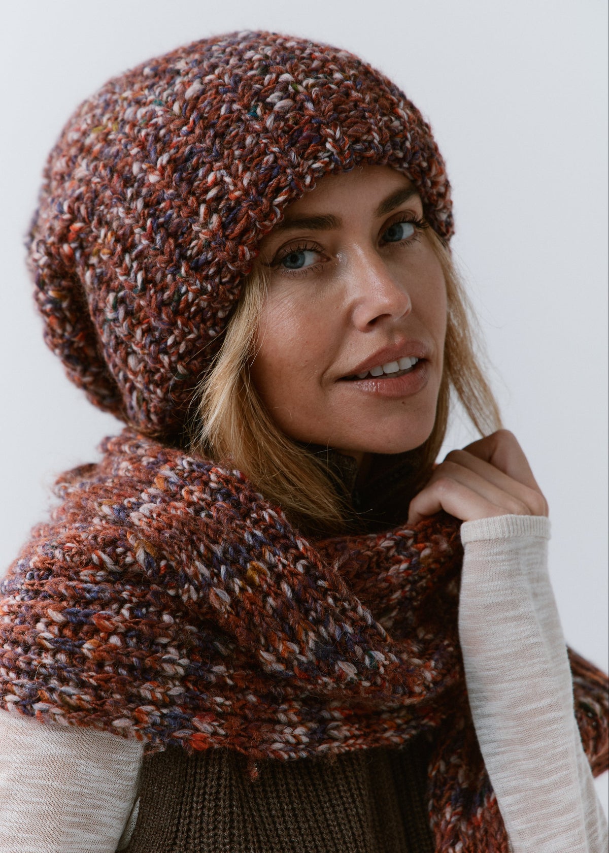 BRIKOLY Eggplant multicolor ribbed knit scarf shown close up around a model's neck beside a matching beanie.