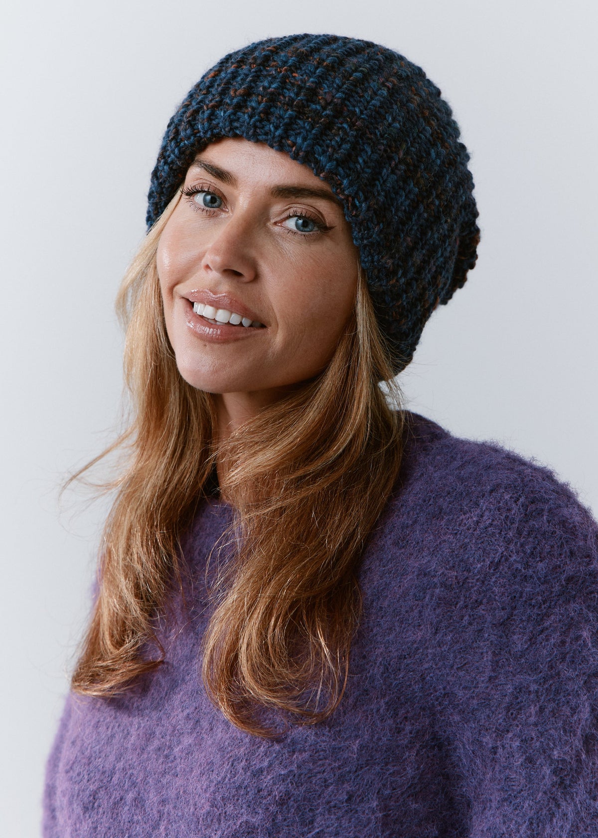 London Dark Lavender knit beanie: Smiling front portrait