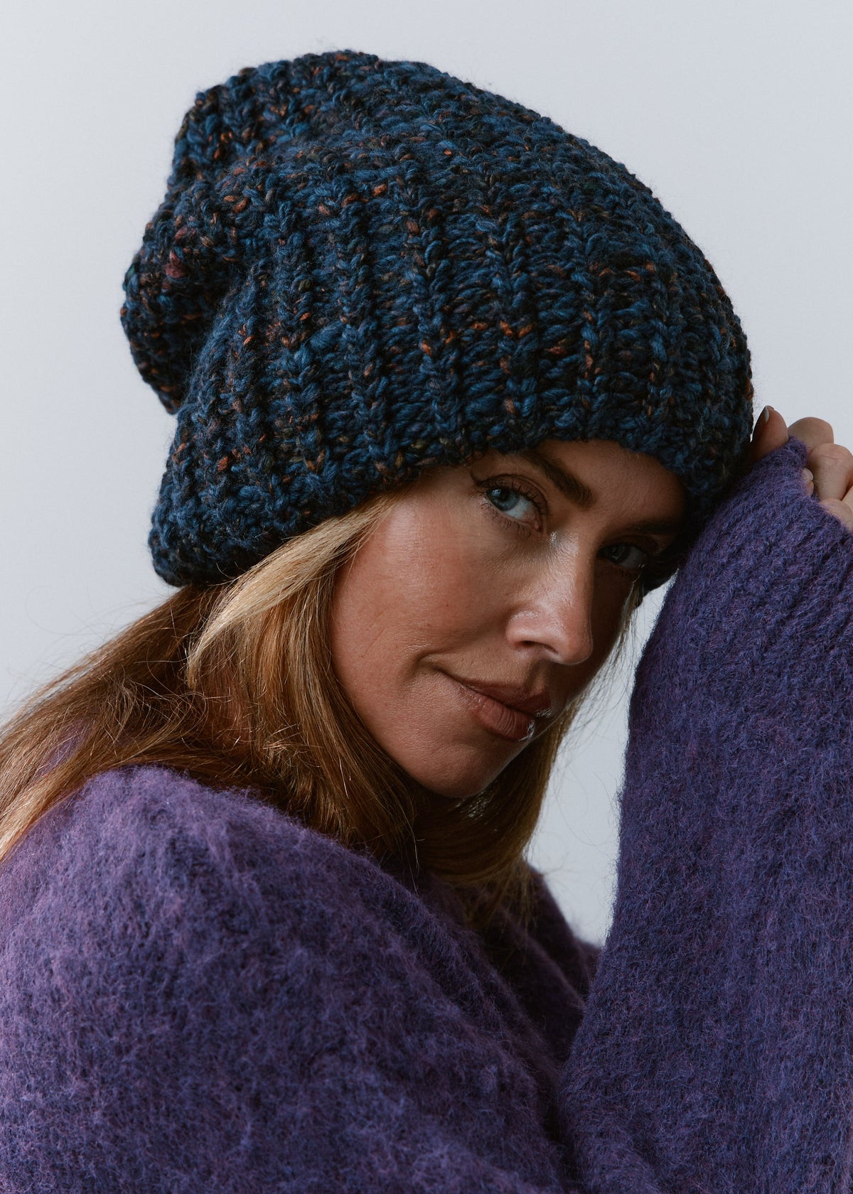 BRIKOLY Dark Lavender oversized knit beanie worn by a model in a close three-quarter view.
