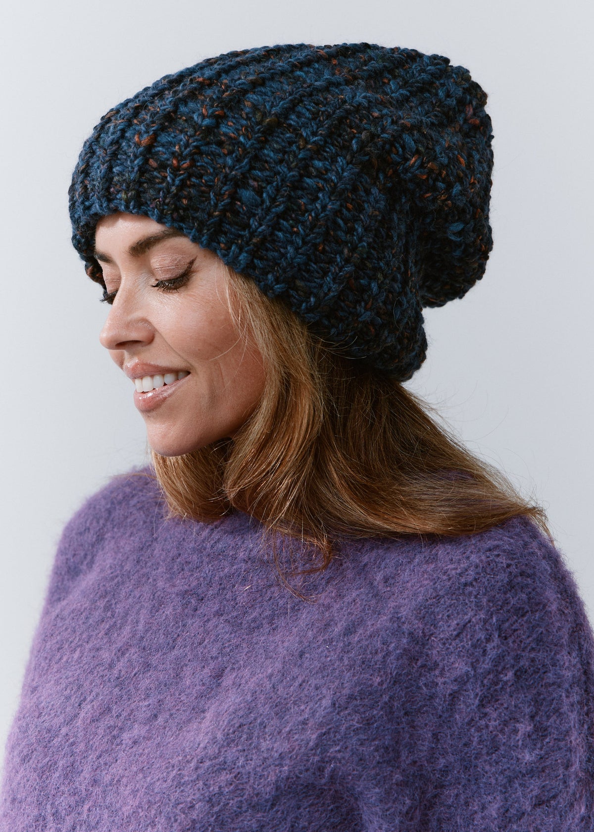 BRIKOLY Dark Lavender oversized knit beanie shown in profile on a model looking down.