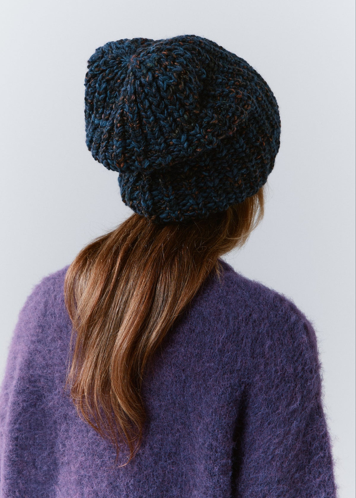 BRIKOLY Dark Lavender oversized knit beanie shown from the back to reveal its loose knit crown.