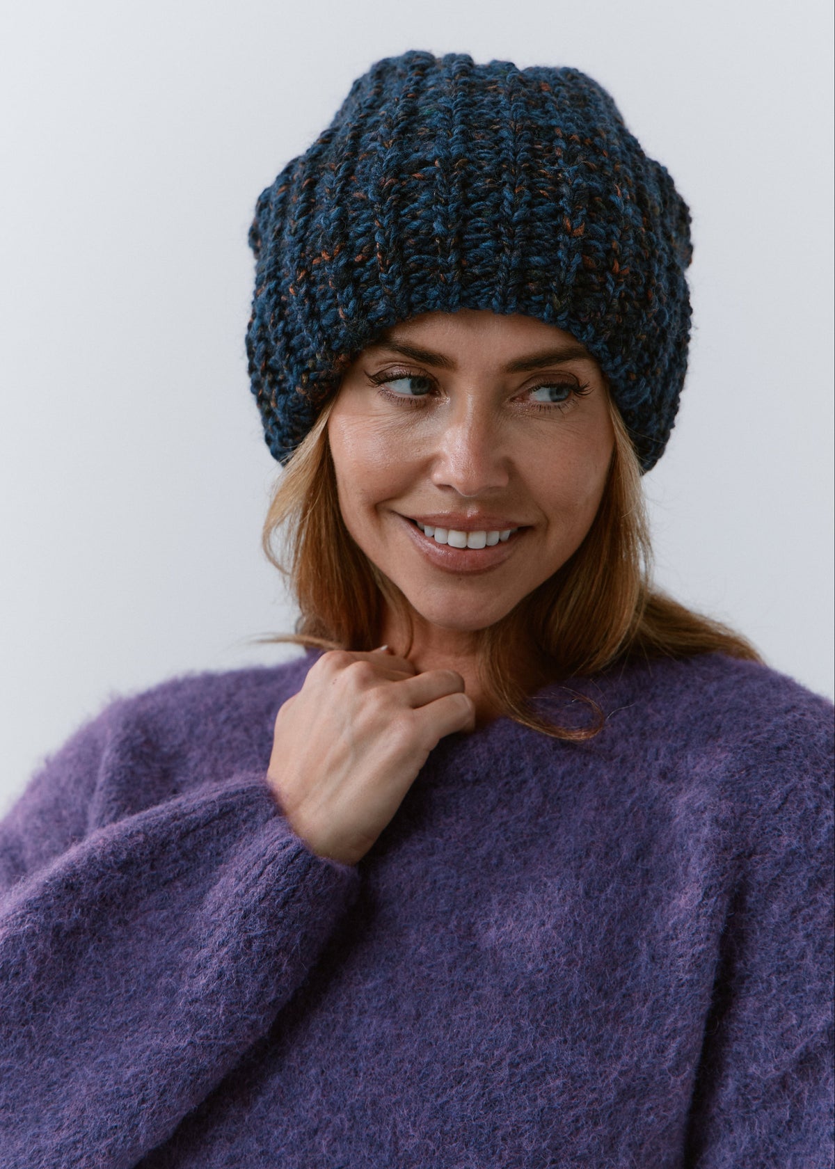 BRIKOLY Dark Lavender oversized knit beanie shown in a close front view on a smiling model.