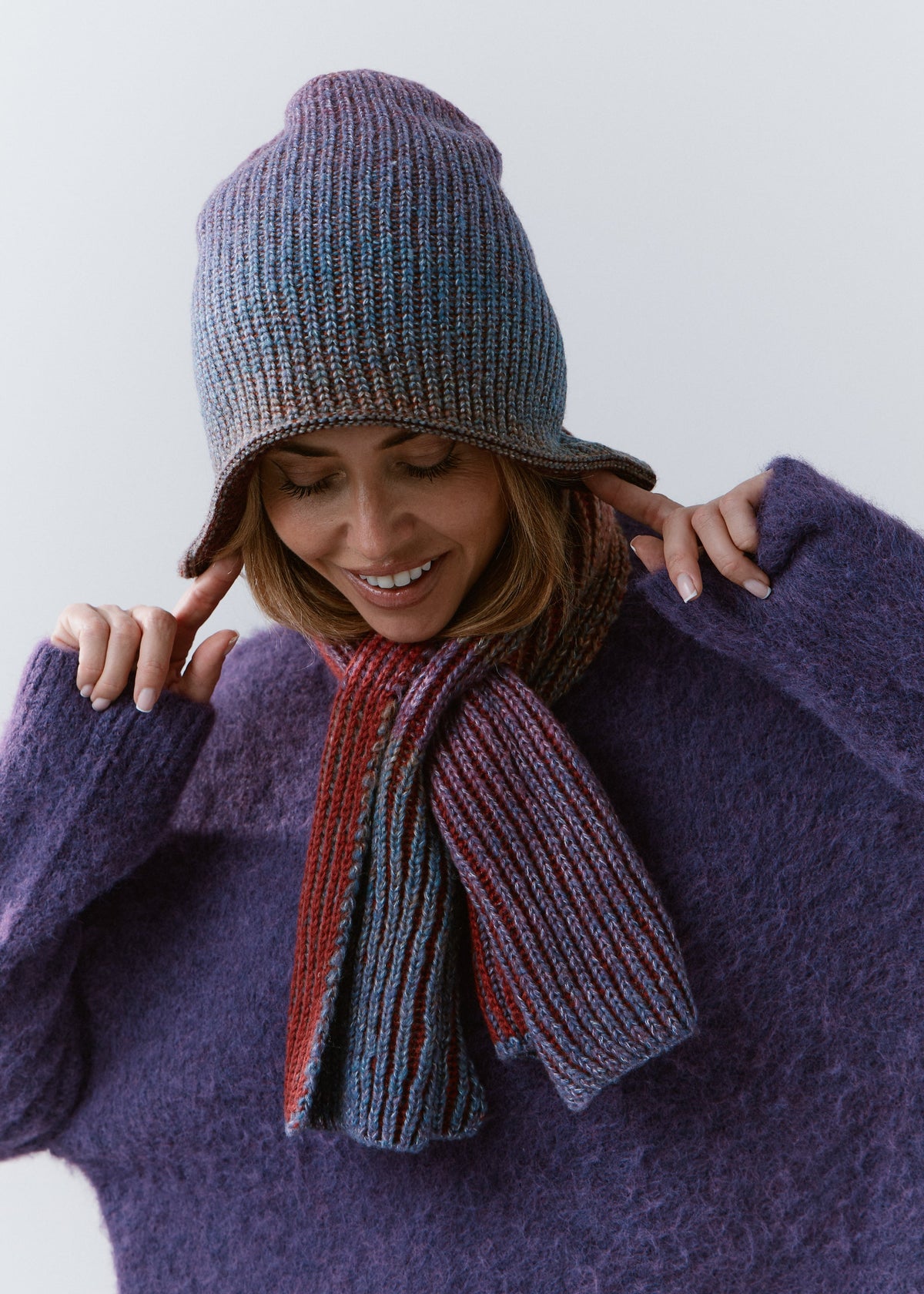 BRIKOLY Lisse Violet multicolor ribbed knit scarf worn by a model looking down with a matching beanie.
