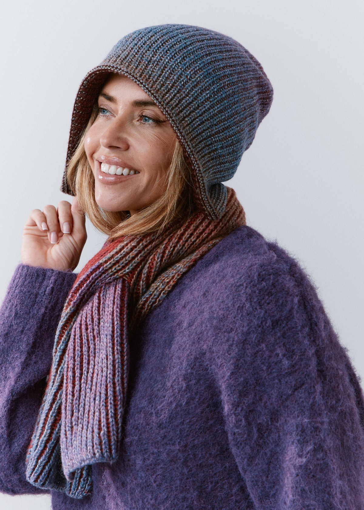 BRIKOLY Lisse Violet multicolor ribbed knit scarf shown in profile on a smiling model.