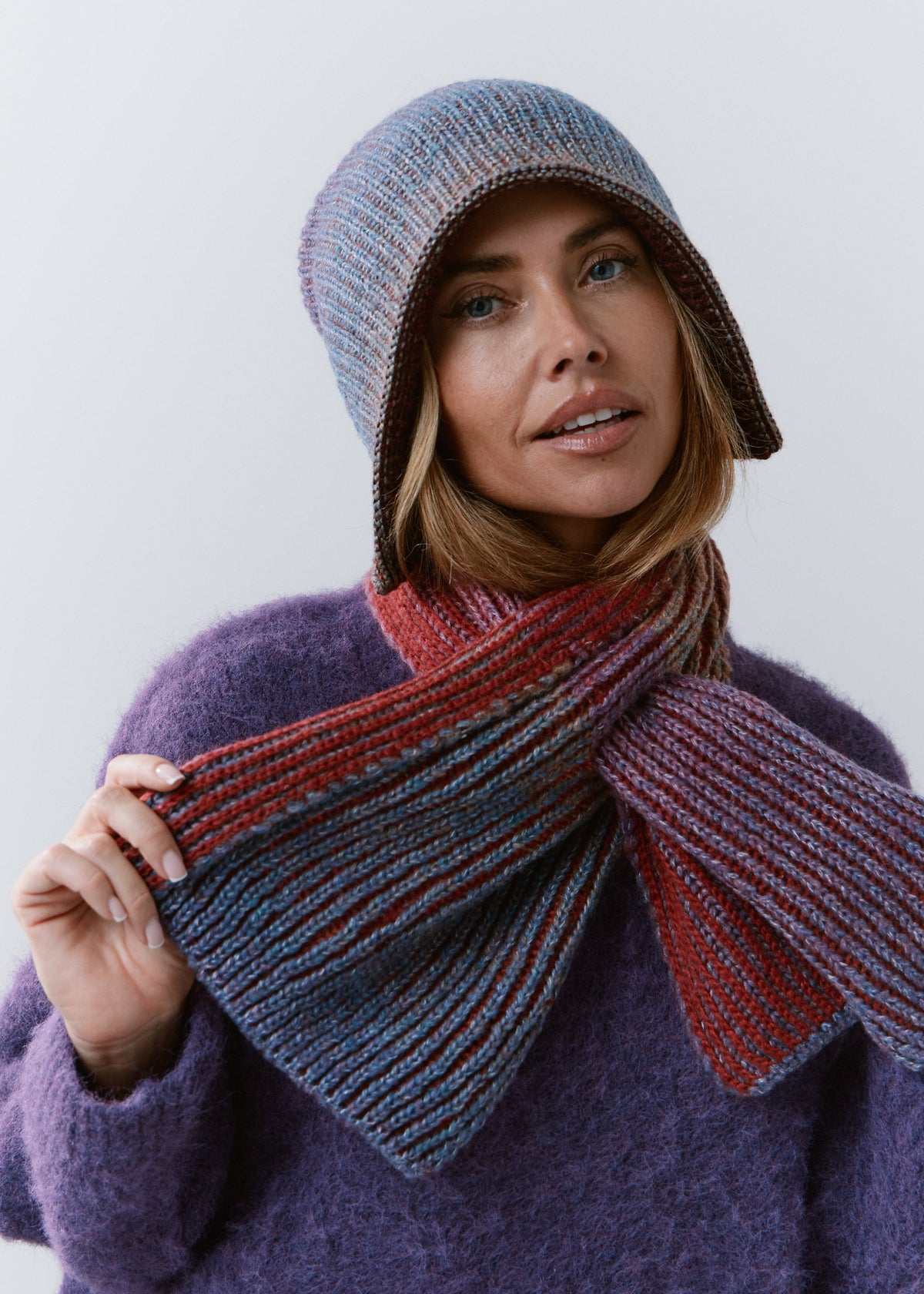 BRIKOLY Lisse Violet multicolor ribbed knit scarf held by a model to show the blue, violet and red ribbed ends.
