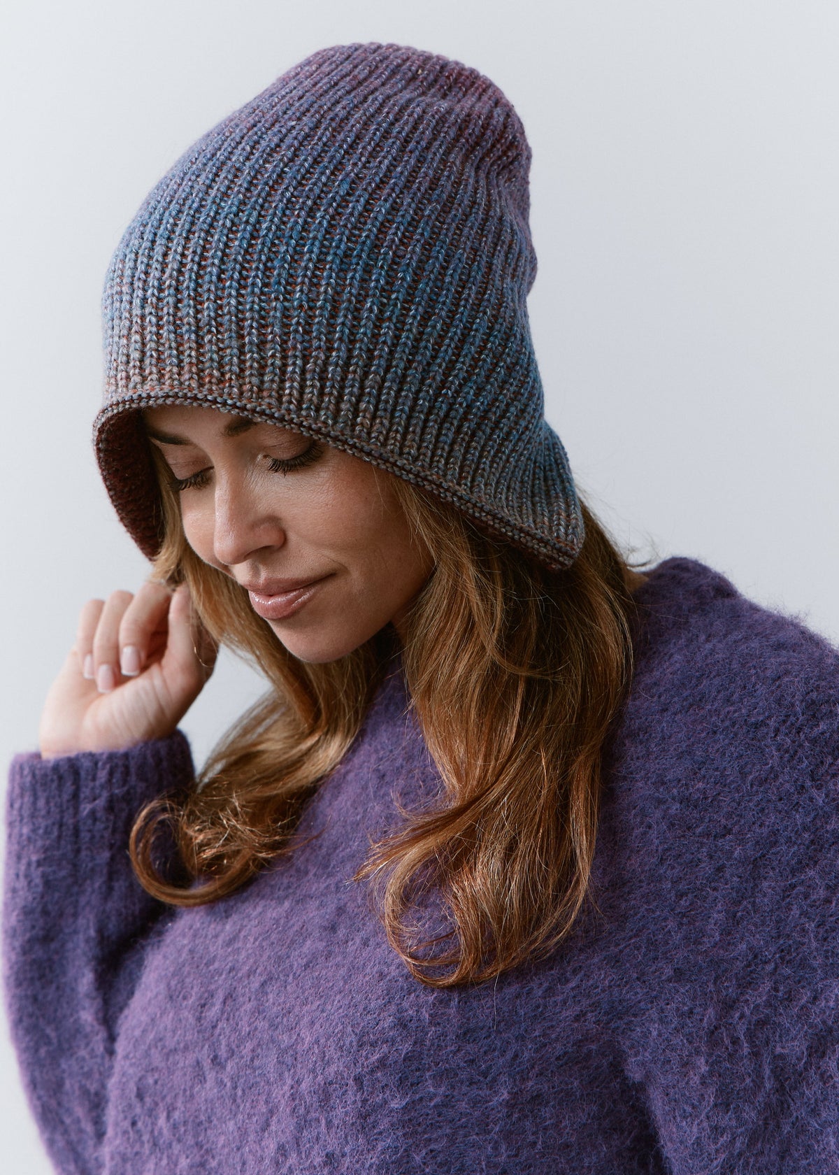 BRIKOLY Lisse Violet reversible ribbed knit beanie shown in a three-quarter view on a model looking down.